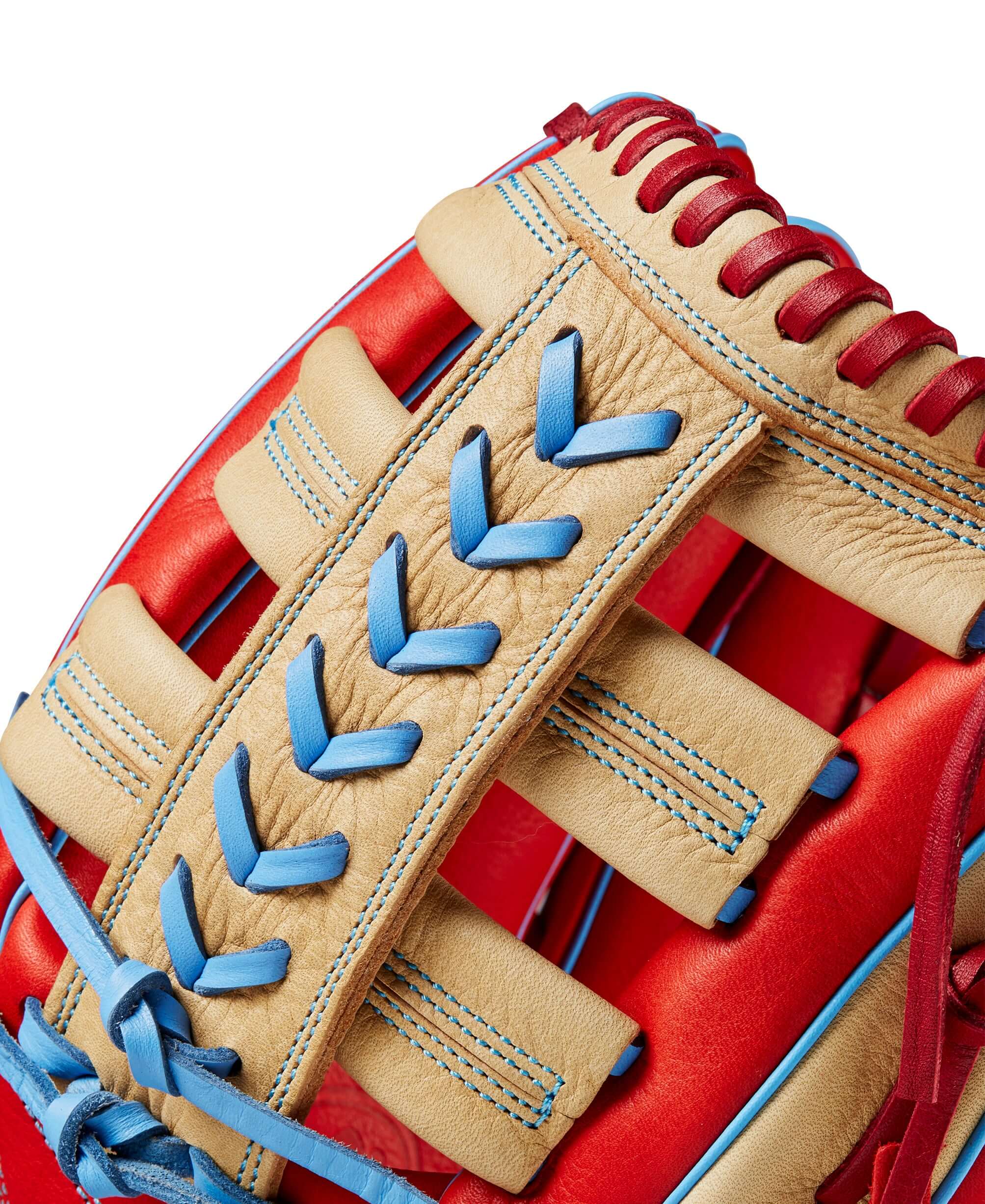 Close-up of Wilson 2024 A1000 PF1892 outfield baseball glove showcasing red, blonde, and blue leather details.