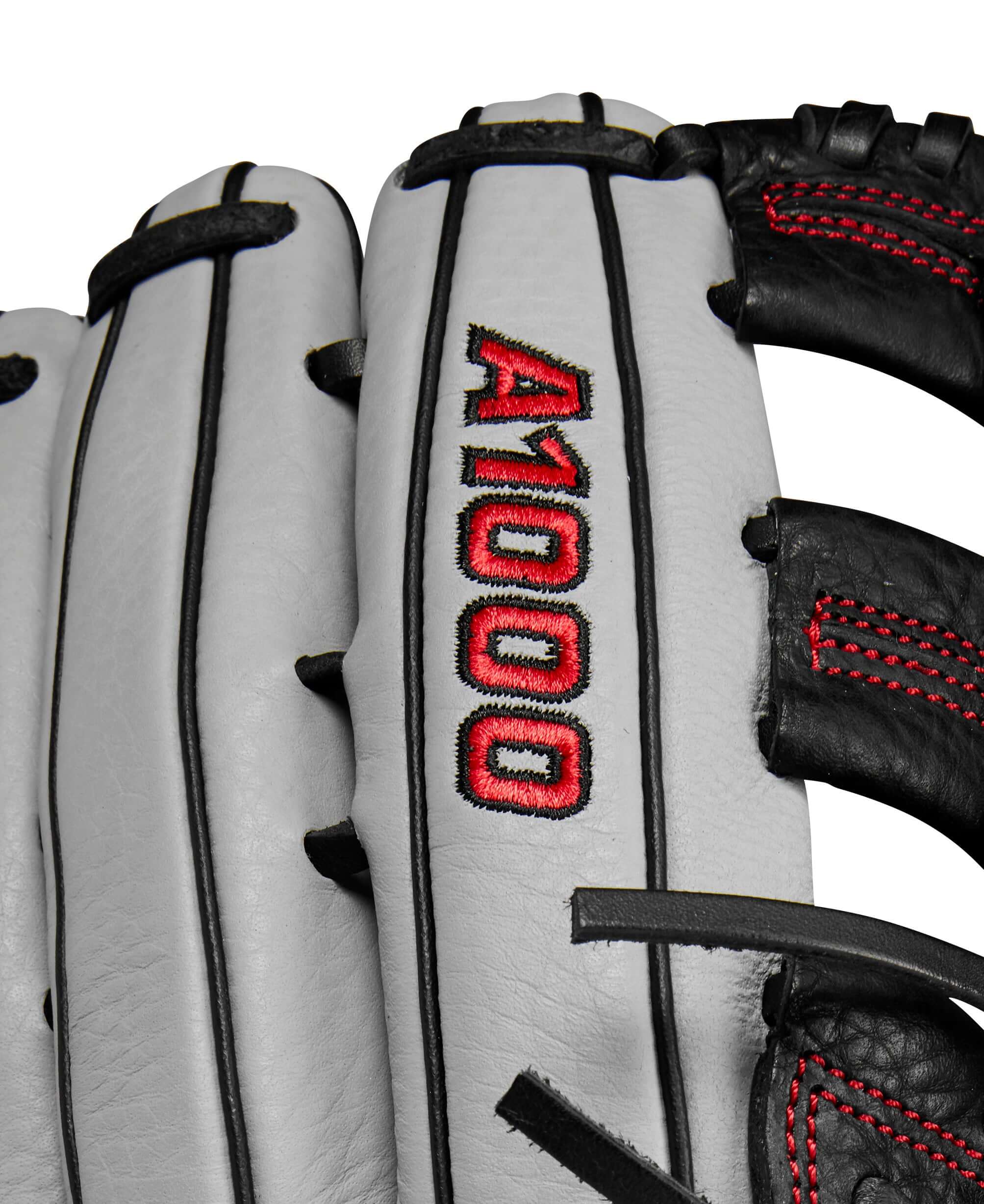 Close-up of the Wilson A1000 1750 outfield baseball glove featuring silver, black, and red colors.
