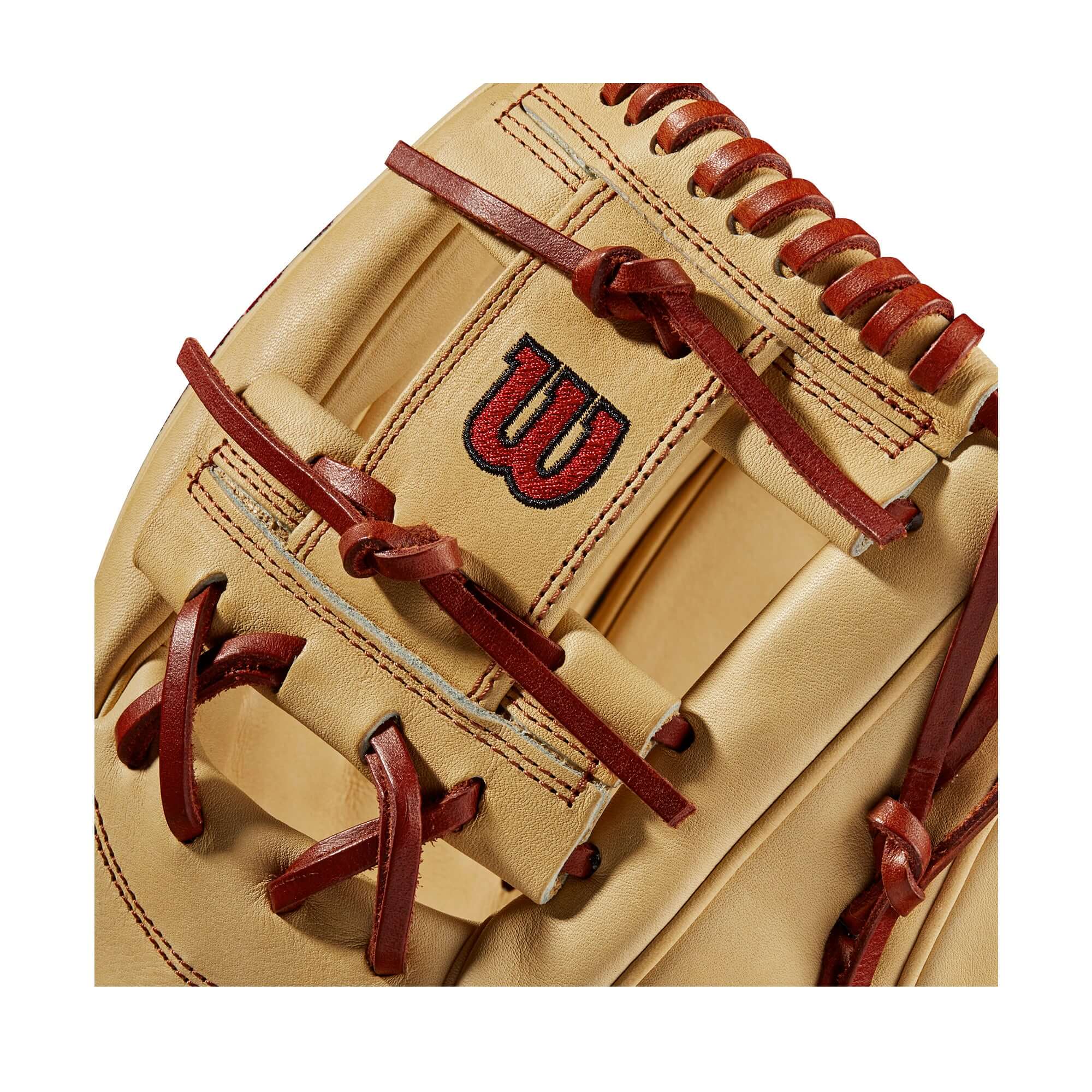 Close-up of Wilson A2000 1787 glove, featuring Blonde leather with Red laces and logo detail, showcasing craftsmanship.