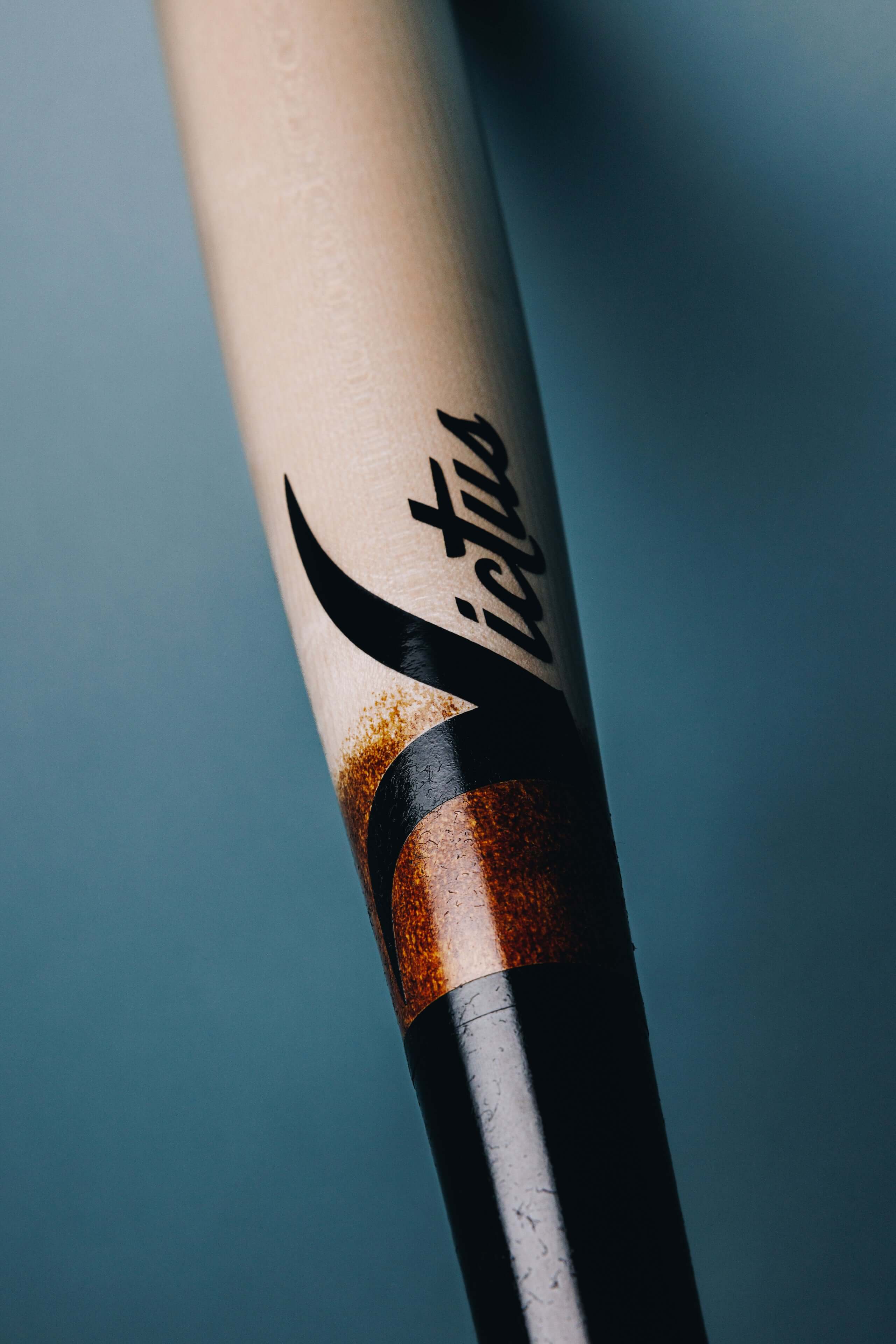 Victus ADLEY35 bat showcasing glossy black and natural wood finish with flared knob and distinctive logo.