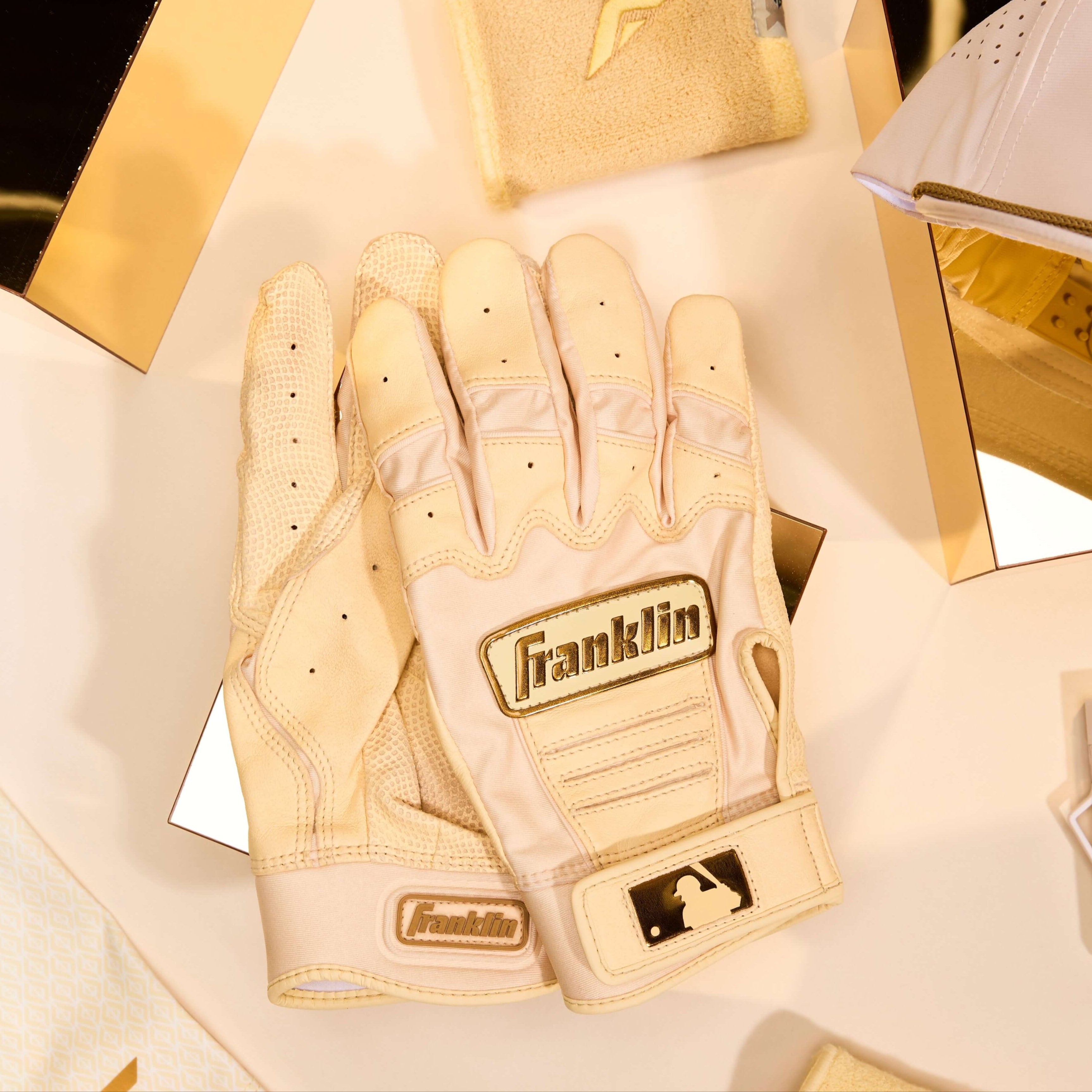 Franklin Adult CFX Pro Vanilla Gold Batting Gloves displayed among premium accessories, highlighting MLB quality and performance.