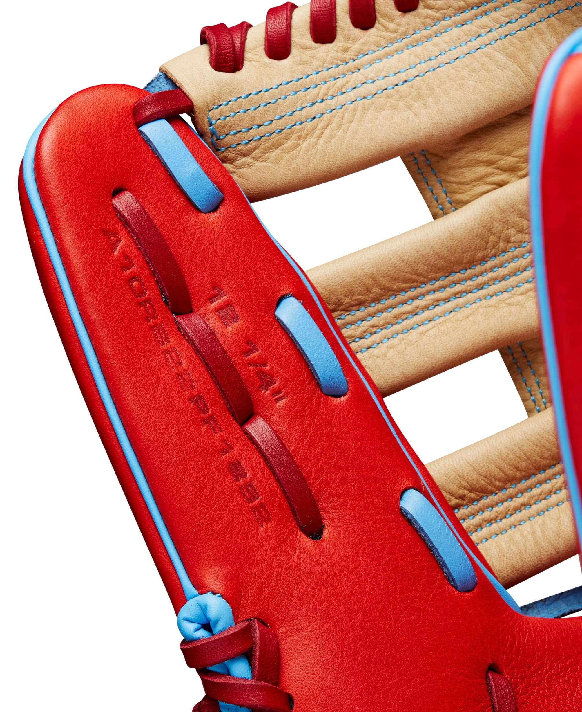 Close-up of the Wilson 2024 A1000 PF1892 outfield baseball glove showing red and blonde leather details.