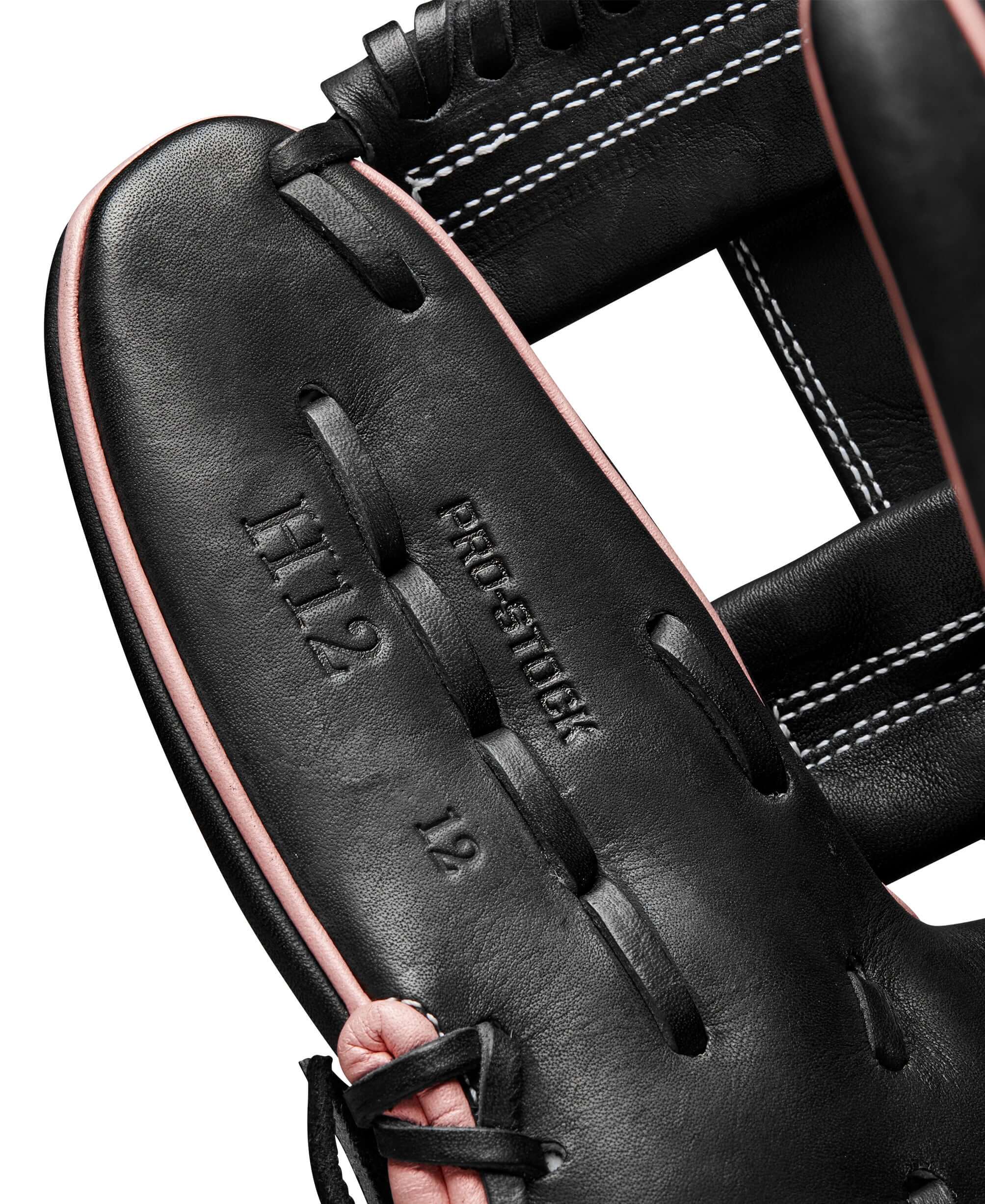 Close-up of Wilson 2024 A2000FP H12 infield glove, featuring Pro Stock leather and distinct black and rose gold design.