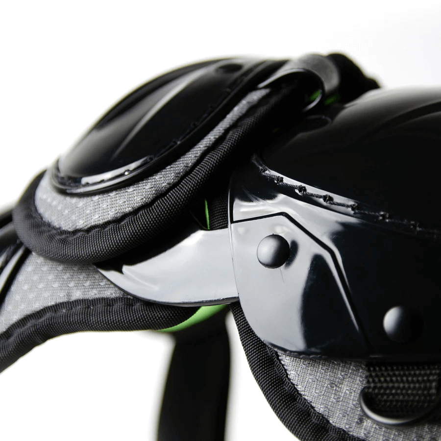 Close-up of Youth System Seven Axis leg guards featuring sturdy black padding and breathable mesh design.