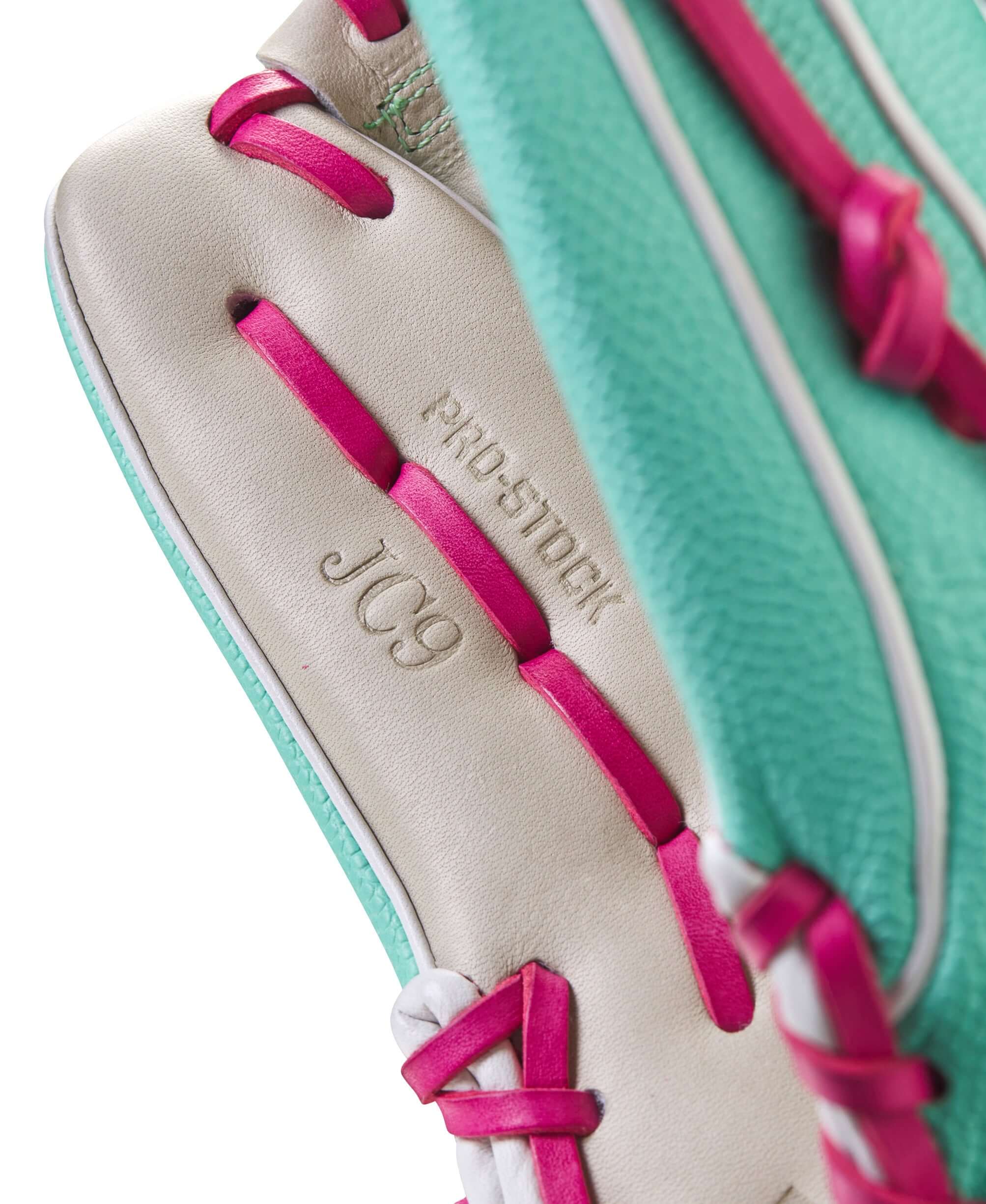Close-up of Wilson A2000 glove showing Pro Stock® leather with pink lacing and JC9 branding for enhanced grip and durability.