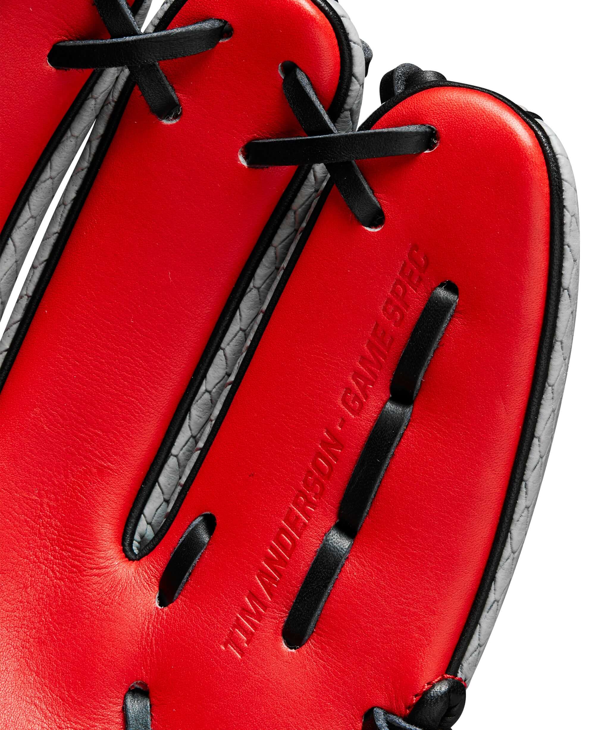 Close-up of the inner palm of the Wilson A2000 Tim Anderson 11.5" baseball glove, showcasing red leather and black lacing.