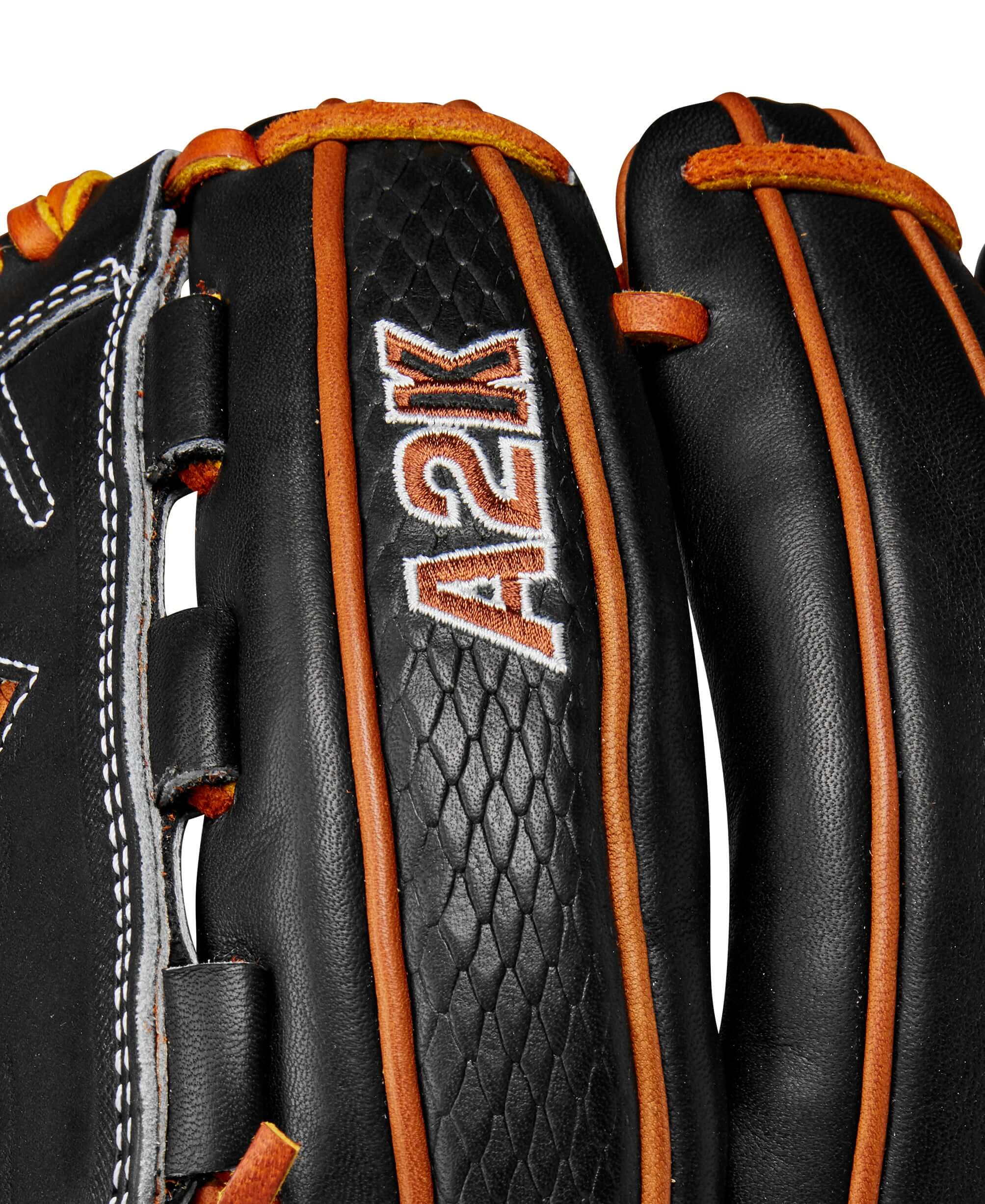 Close-up of Wilson A2K B23 baseball glove showing black leather, orange accents, and detailed stitching.