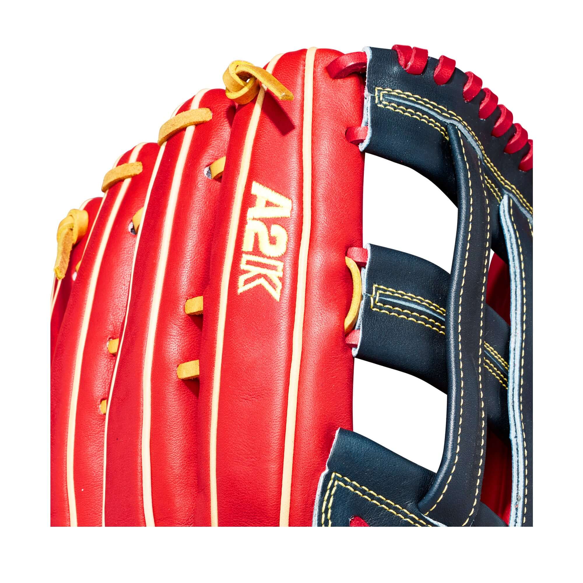 Close-up of Wilson A2K JS22 GM baseball glove in red and black leather with yellow stitching, showcasing its quality and design.