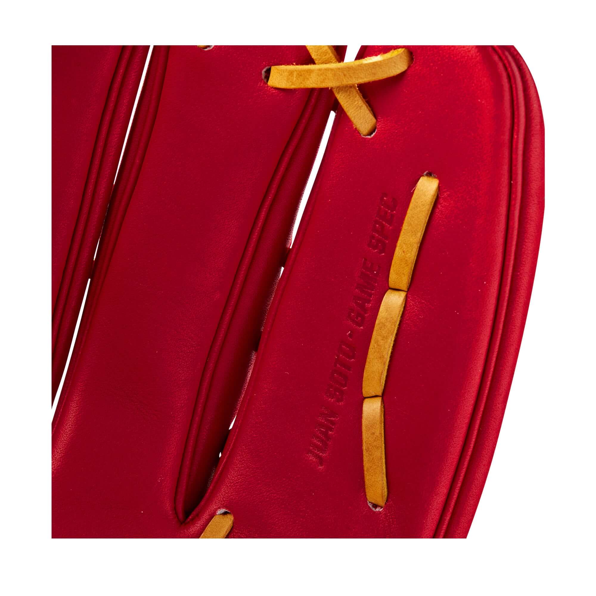 Close-up of the interior of the Wilson 2022 Juan Soto baseball glove featuring red leather and yellow lacing.