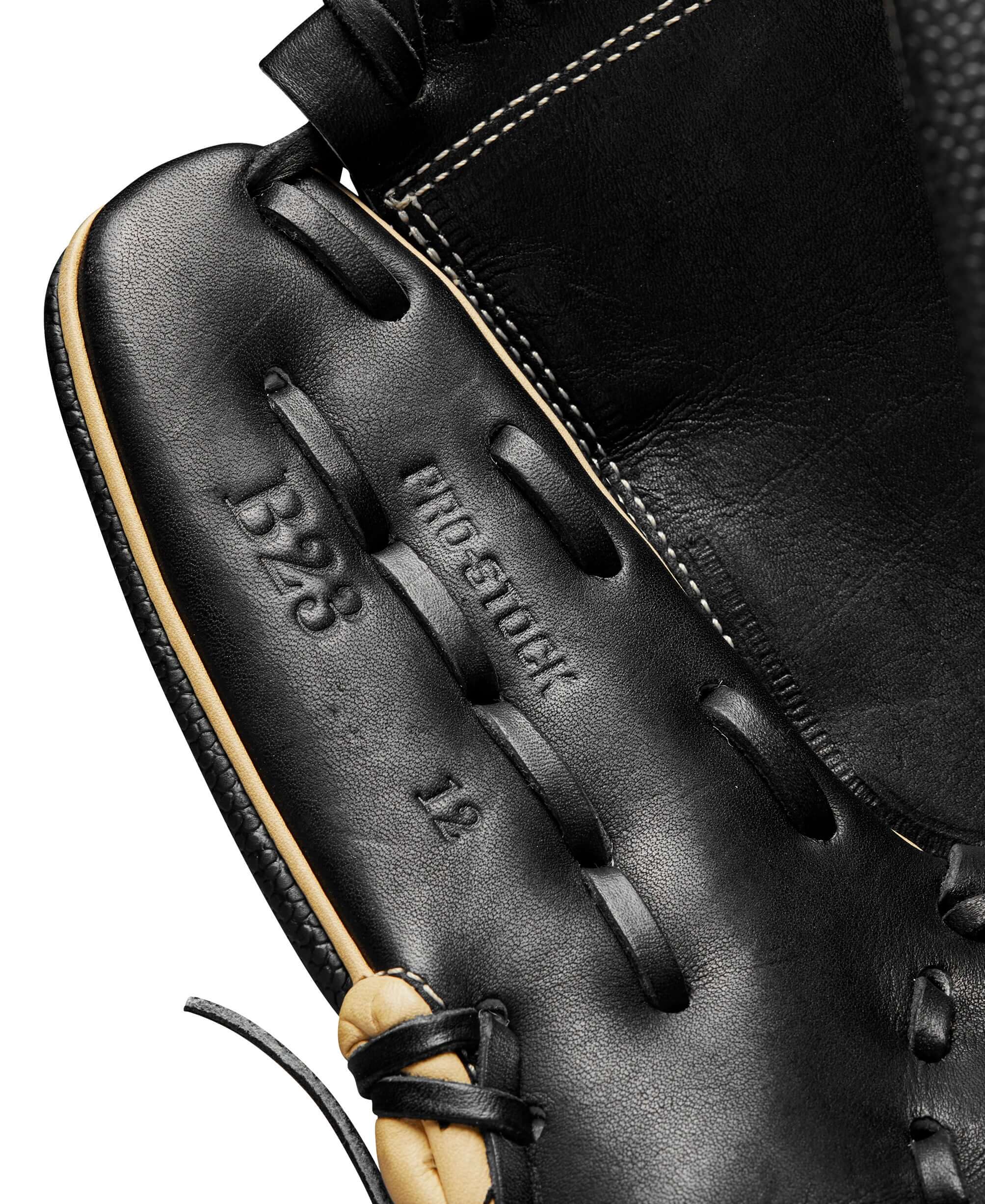 Close-up of the Wilson A2000 B23 baseball glove showing black leather and manufacturer details.
