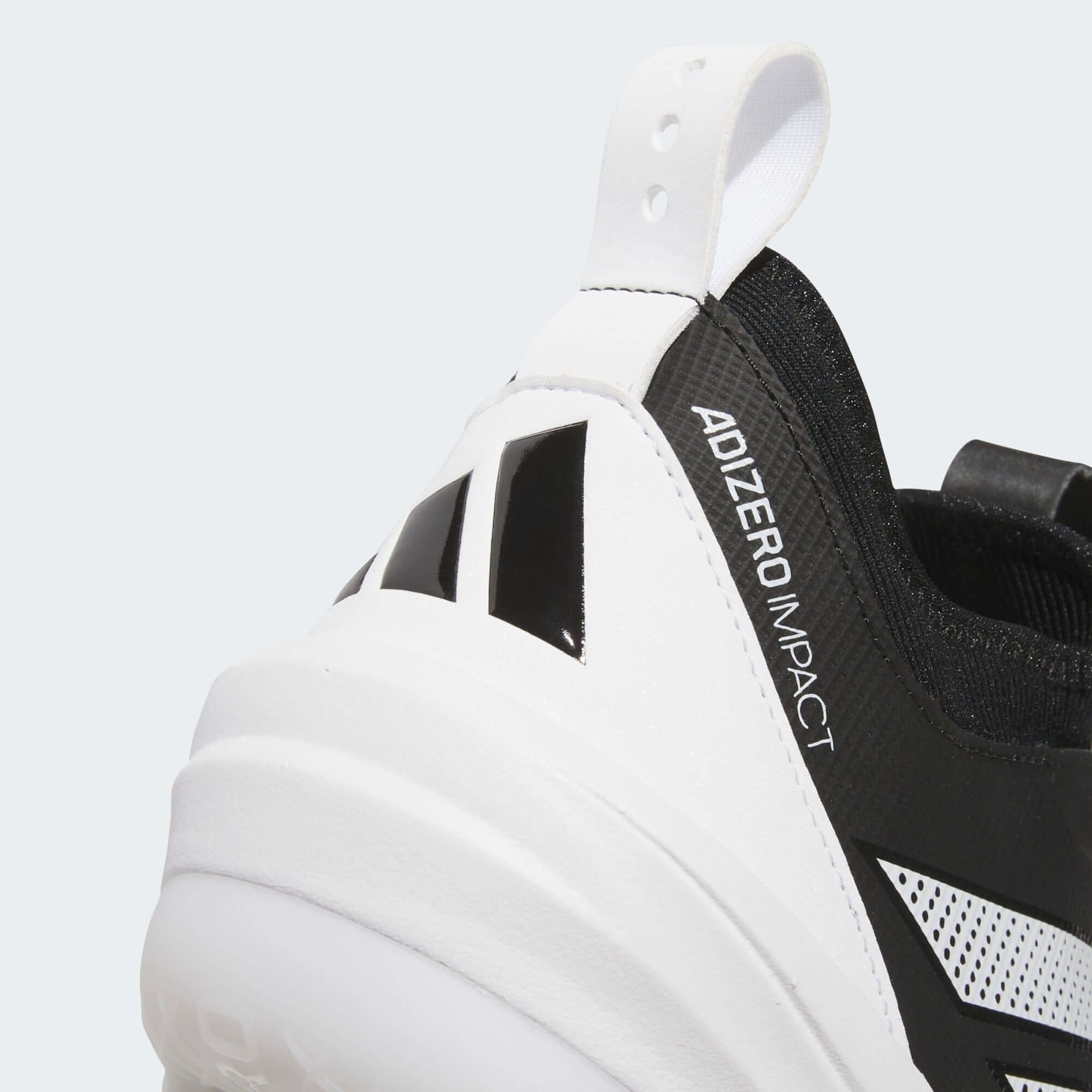 Close-up of Adidas Adizero Impact 2.0 baseball cleats showing knit bootie and sleek design in black and white.