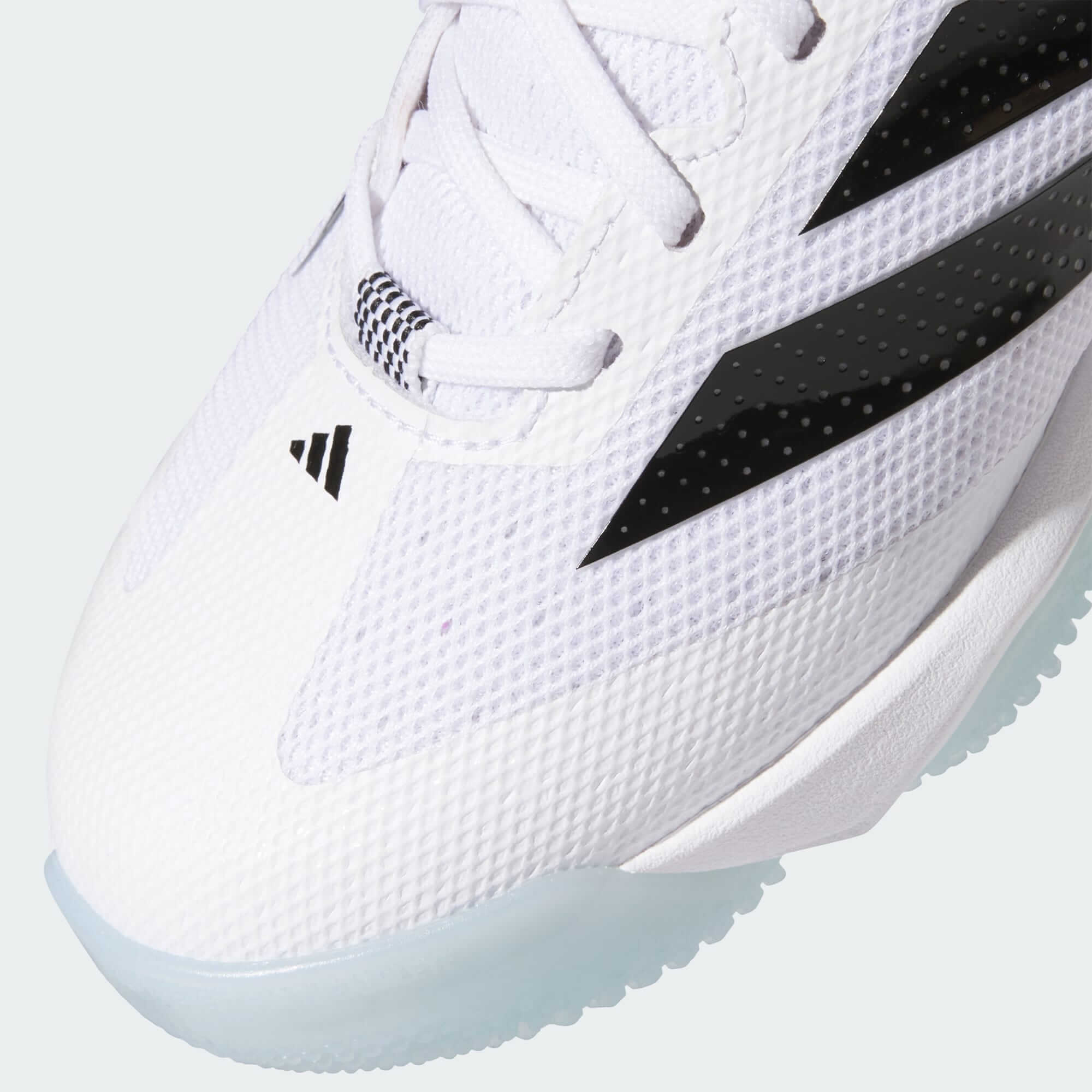 Adidas Adizero Impact 2.0 Turf shoes close-up showing lightweight white upper and black stripes for baseball performance.