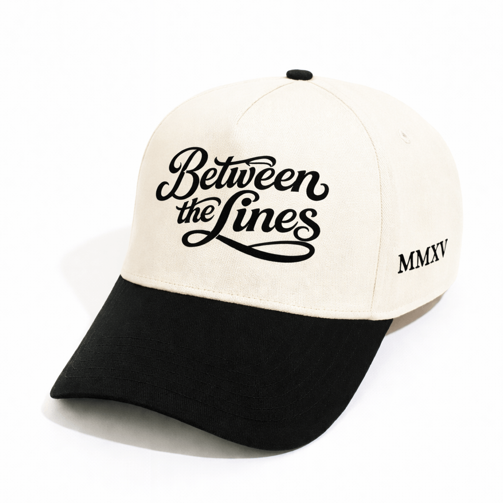 BTL Cursive MMXV A-Frame Snapback with black brim, Between the Lines logo on front, and MMXV embroidery on side.
