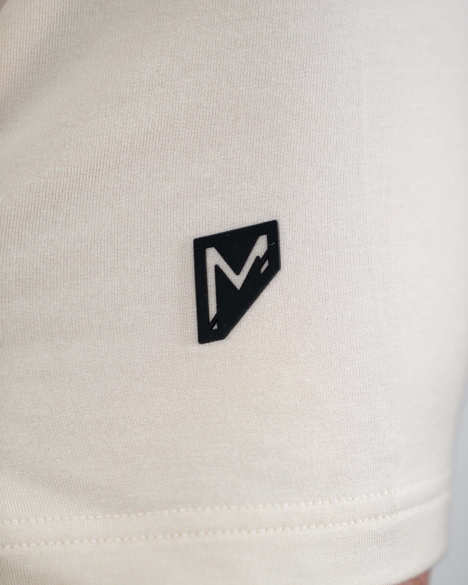 Close-up of Bauer OutageTan Short Sleeve Hoodie featuring the logo on the sleeve, showcasing premium design and quality.