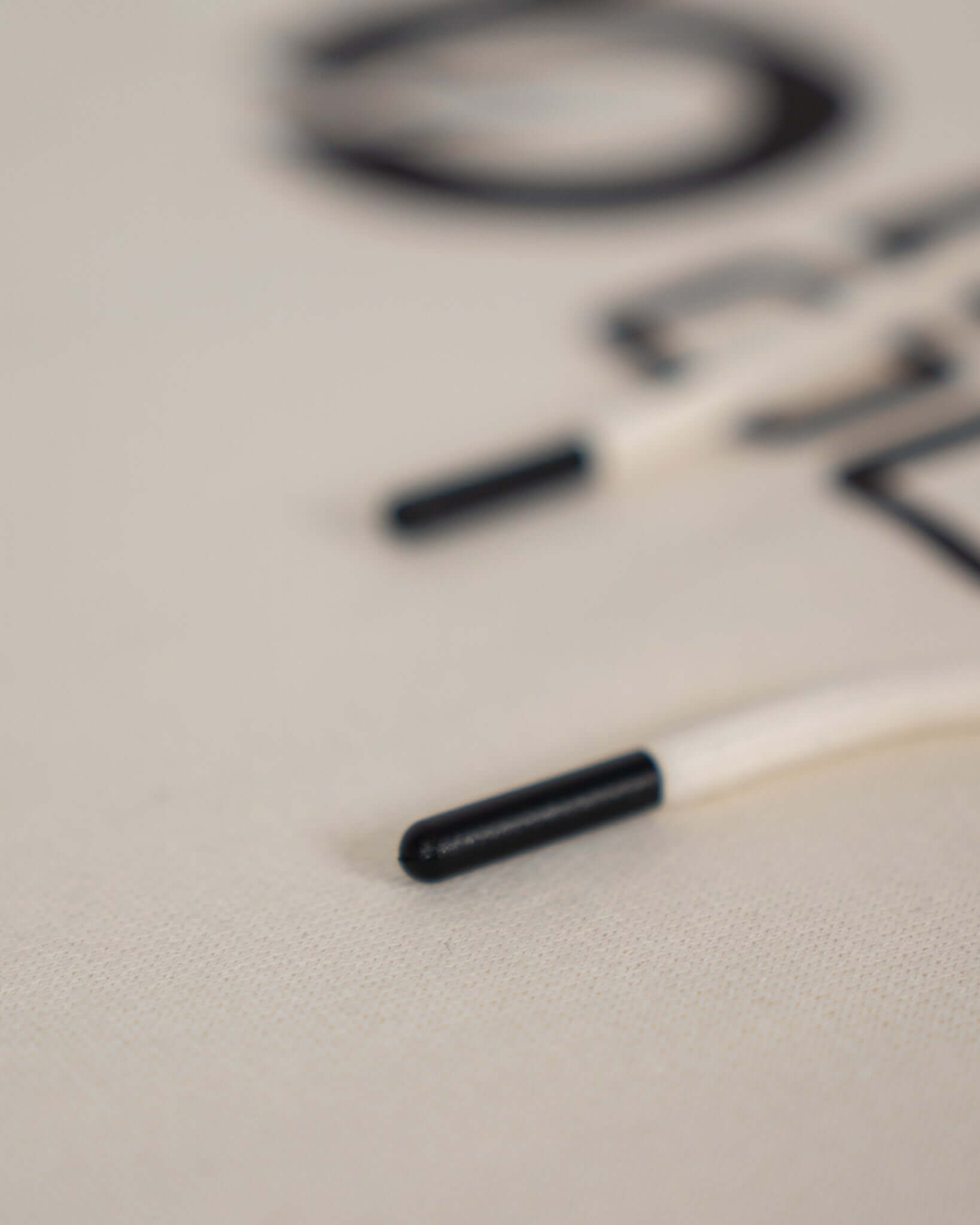 Close-up of the drawstrings on a beige Bauer Outage Heavyweight Hoodie showcasing its quality design.