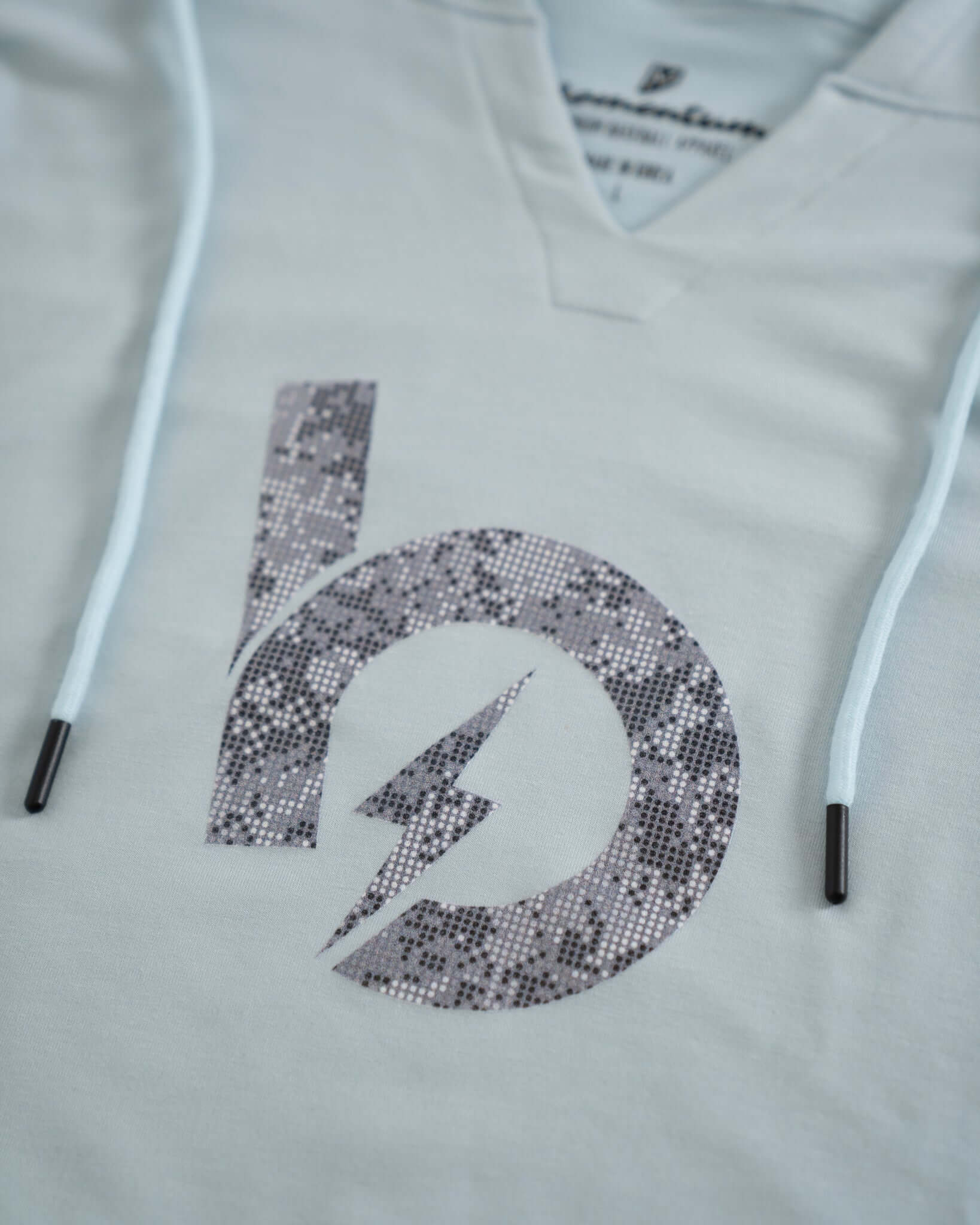 Close-up of Bauer Outage Lightweight Hoodie featuring a stylish notch-neck collar and sparkly logo design.