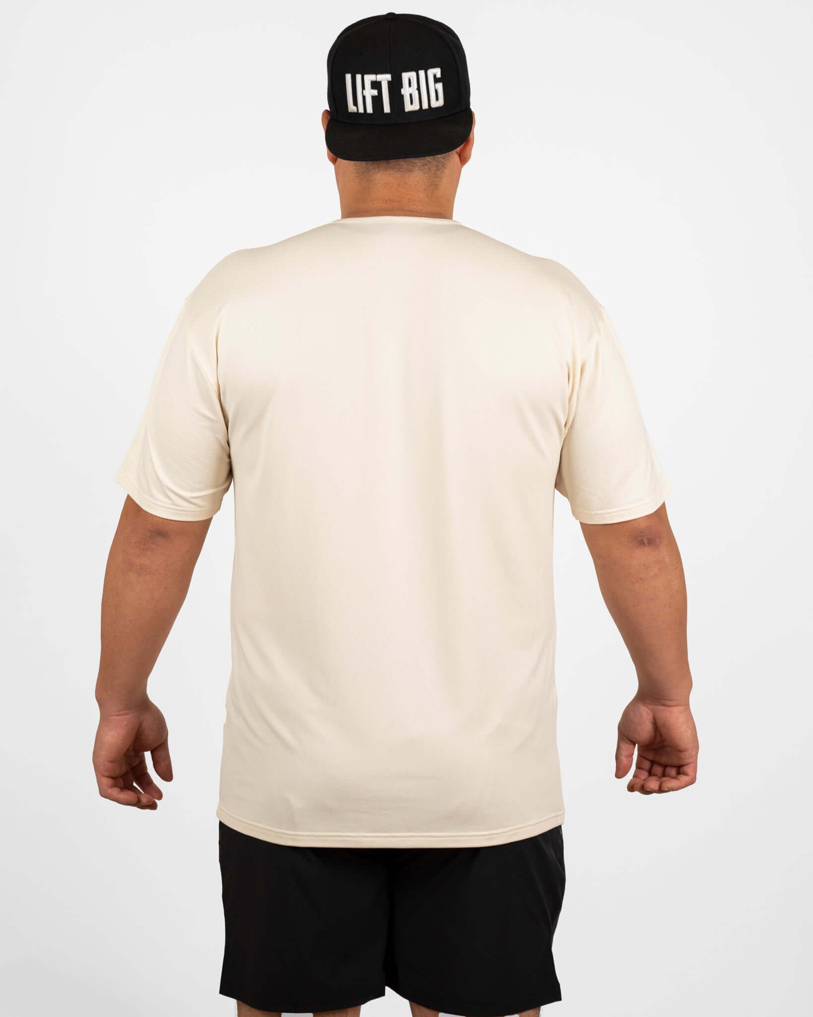 Man wearing King of Juco Tan Recovery Tee from the back, showcasing its relaxed fit and breathable fabric.