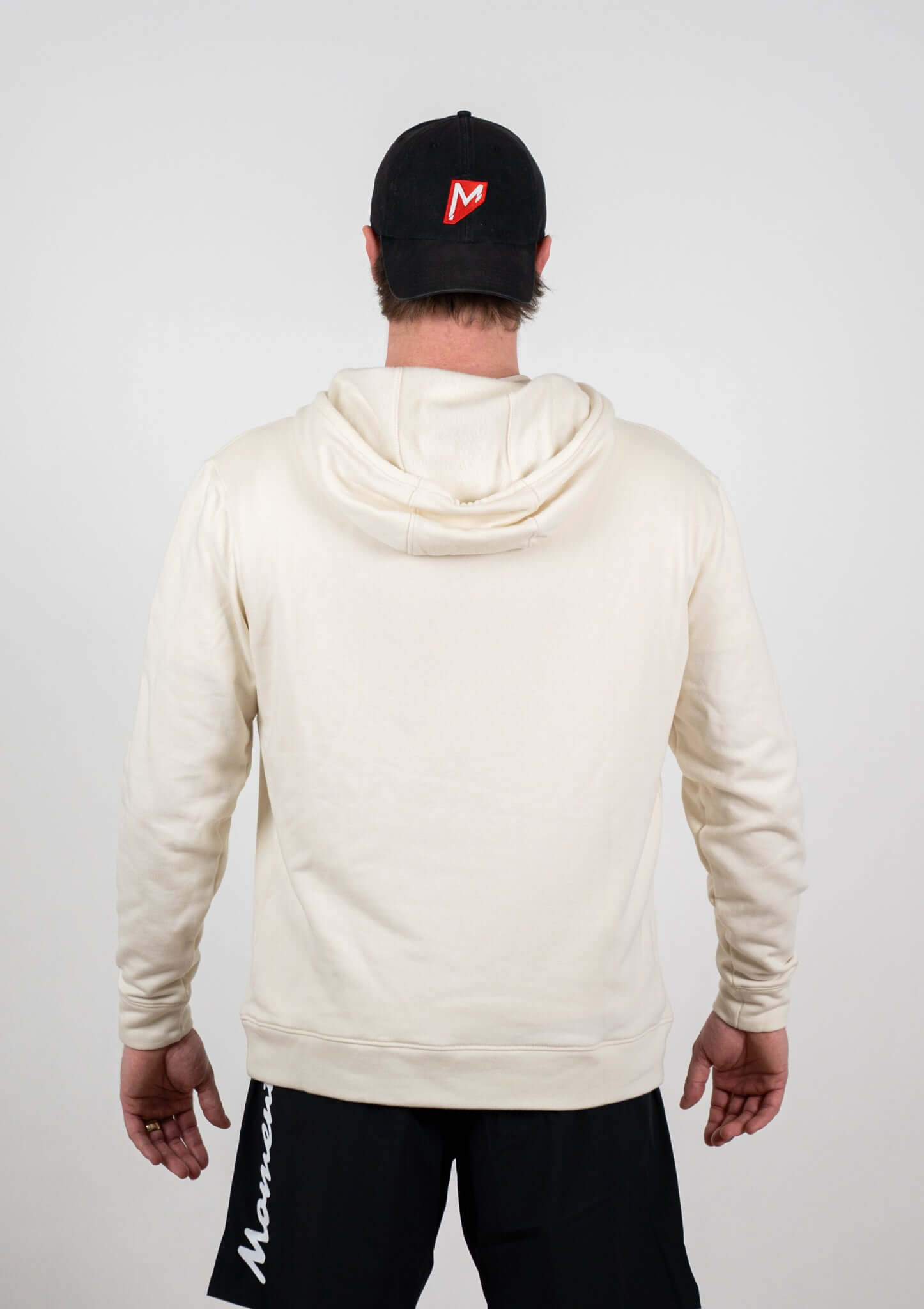 Back view of a person wearing a Momentum Tan Heavyweight Hoodie, showcasing its cozy design and relaxed fit.