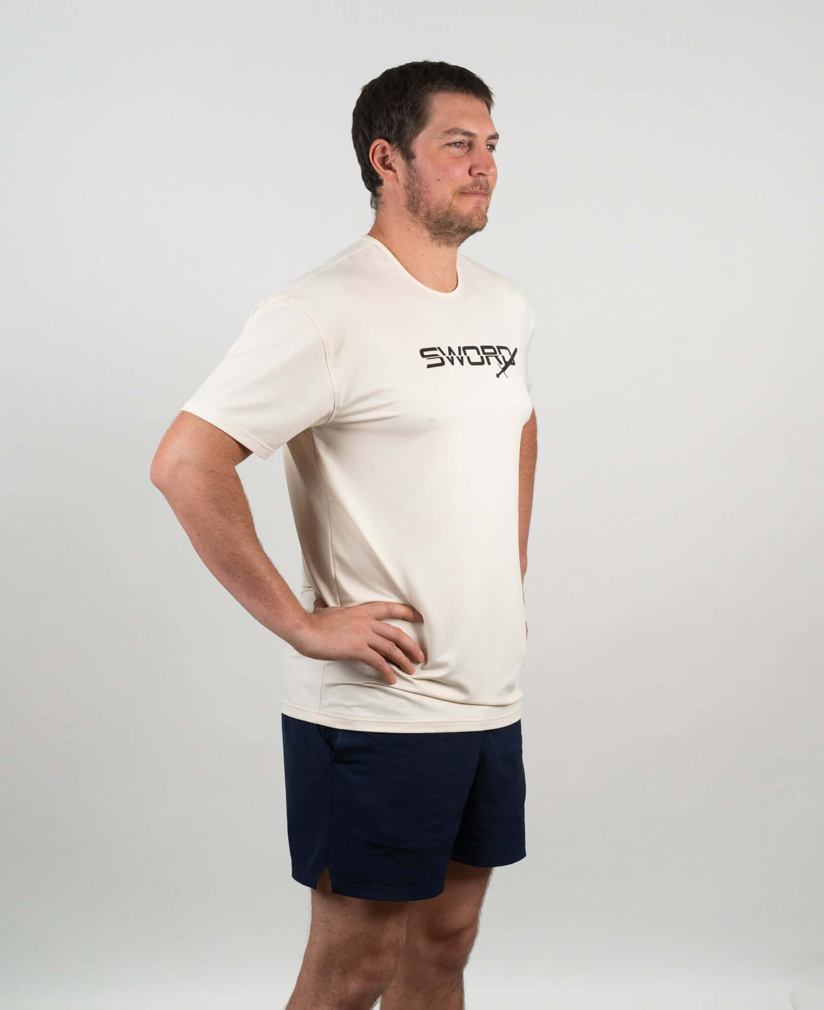 Bauer Outage Tan Recovery Tee on a male model, showcasing relaxed fit and breathable fabric for post-workout comfort.
