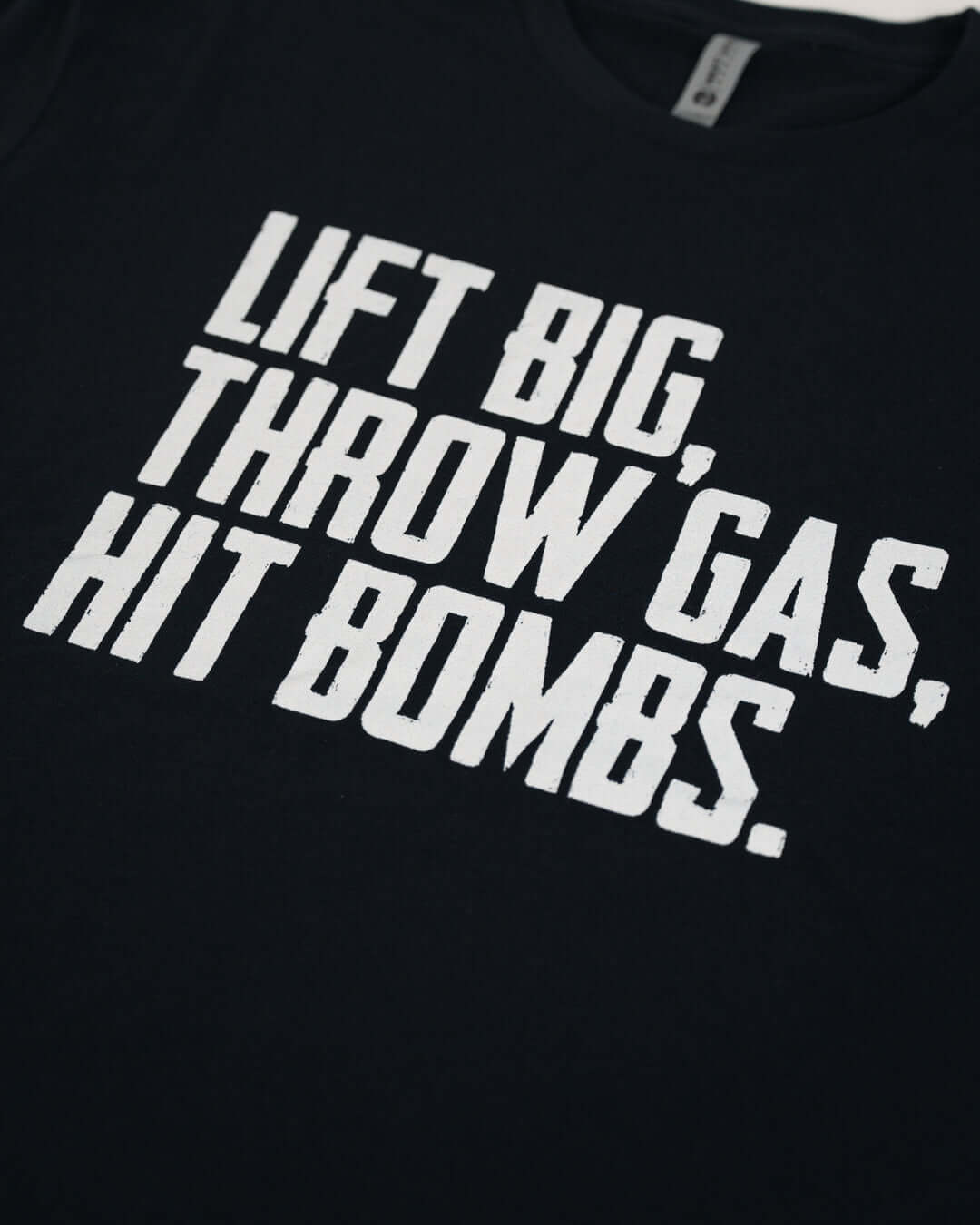 Lift Big Throw Gas Hit Bombs T-Shirt design in black fabric with bold white text.