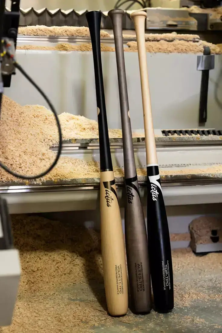 Victus Top Torpedo Pro Reserve wood bats displayed in a workshop, showcasing their craftsmanship and quality.