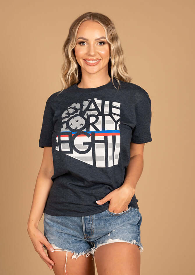 Woman modeling State Forty Eight men's crew shirt in midnight navy with bold graphic design and casual style.
