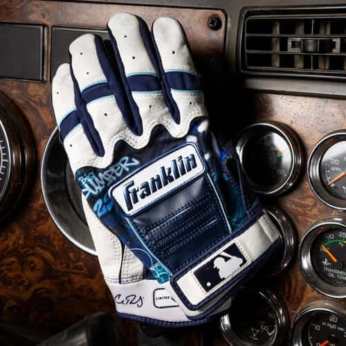 Franklin Cal Raleigh Limited Edition CFX Pro glove backhand view with blue details on car dashboard