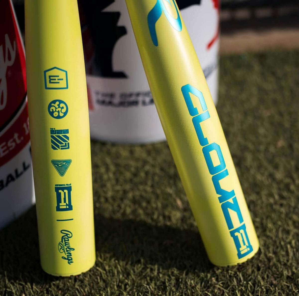 Barrel close-up of 2026 Rawlings Clout AI (-3) BBCOR Baseball Bat showing blue graphics and certification marks on yellow alloy.