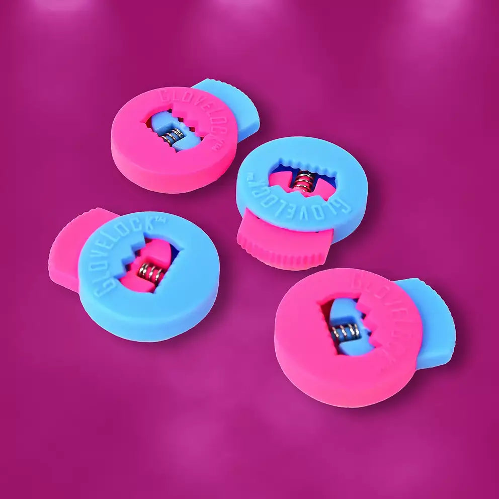 Four All-Star Glovelocks 4 Pack Lace Clips Limited Edition in pink and blue on a magenta surface.