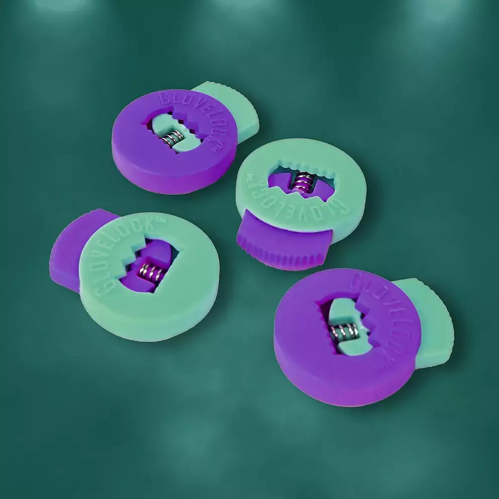 All-Star Glovelocks 4 Pack Lace Clips Limited Edition in purple and green shown on a green background, close-up view.