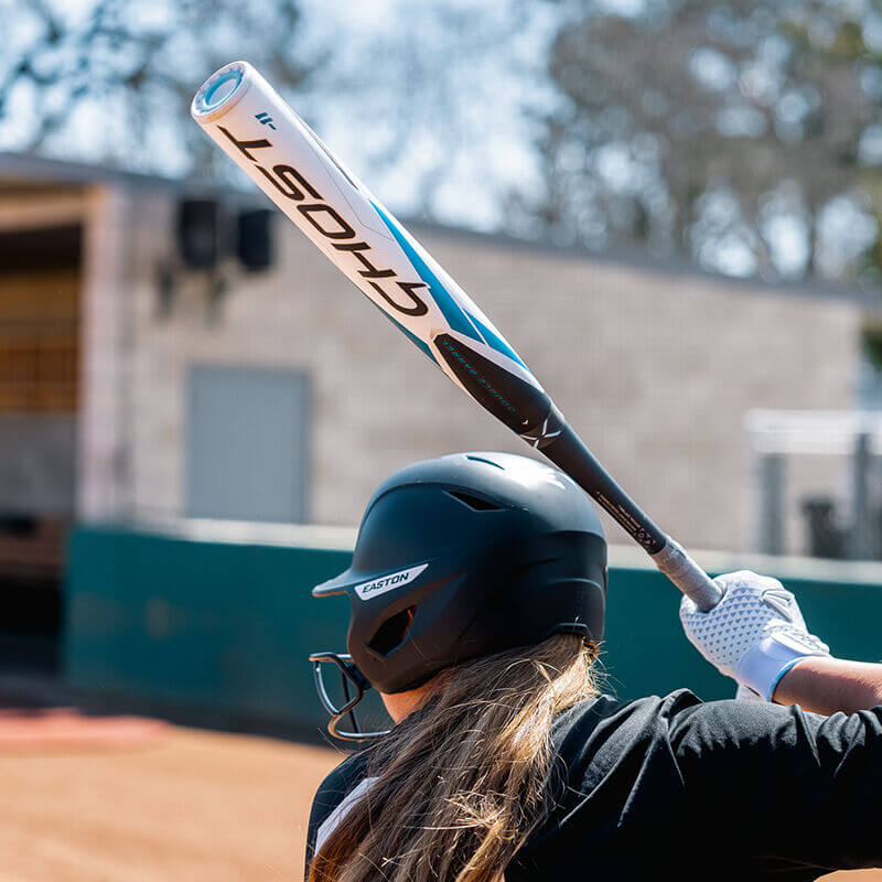 Player swinging the Easton Ghost -10 Fastpitch Softball Bat during practice at a softball field.