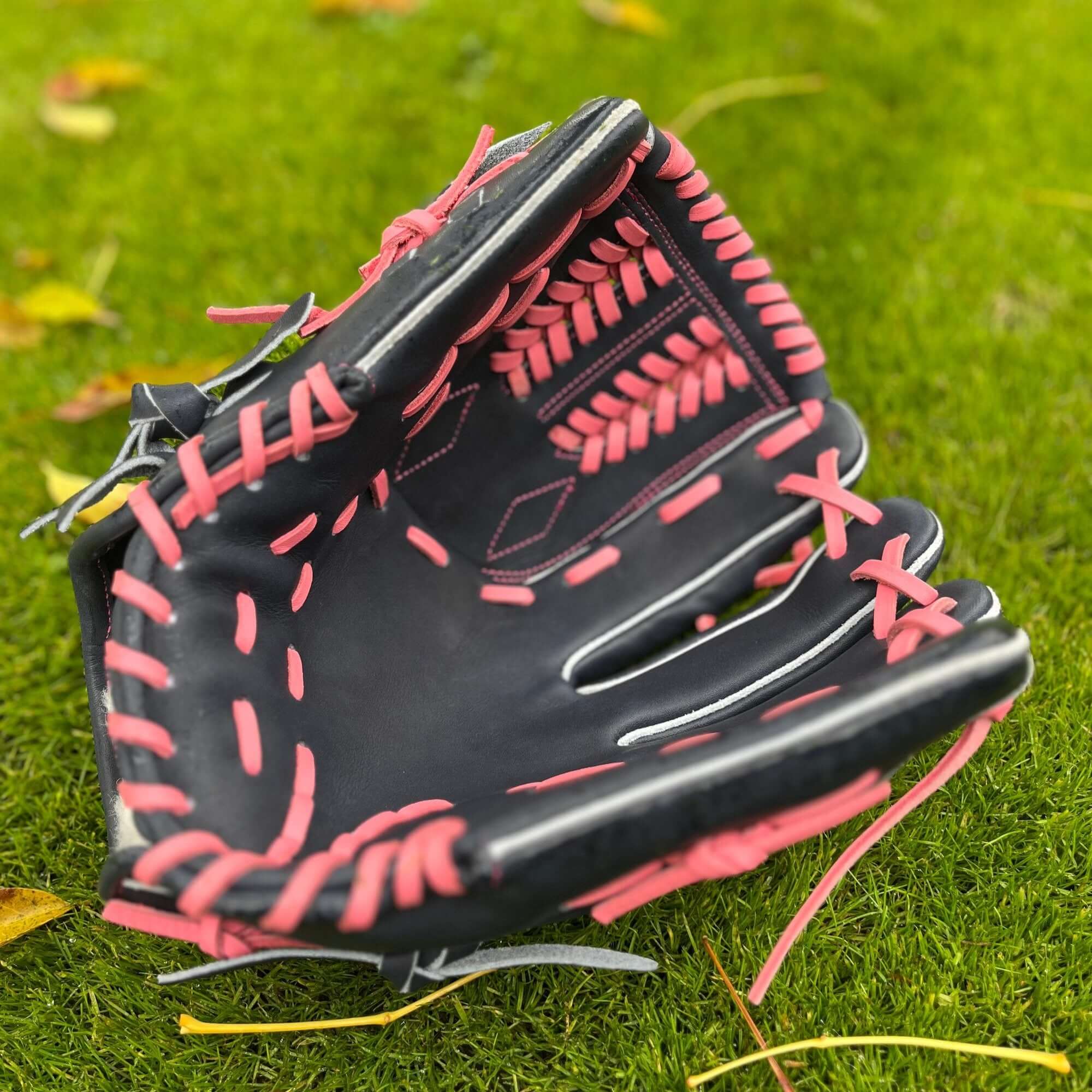 Front view of The Glove Lab Navy/Pink 12" pitcher's glove, featuring closed web design.