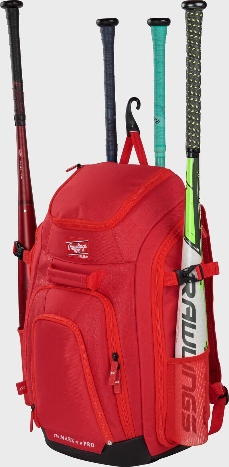 Side view of Rawlings Legion 2 Players Backpack in red, featuring compartments, three bat holders, and side pockets.