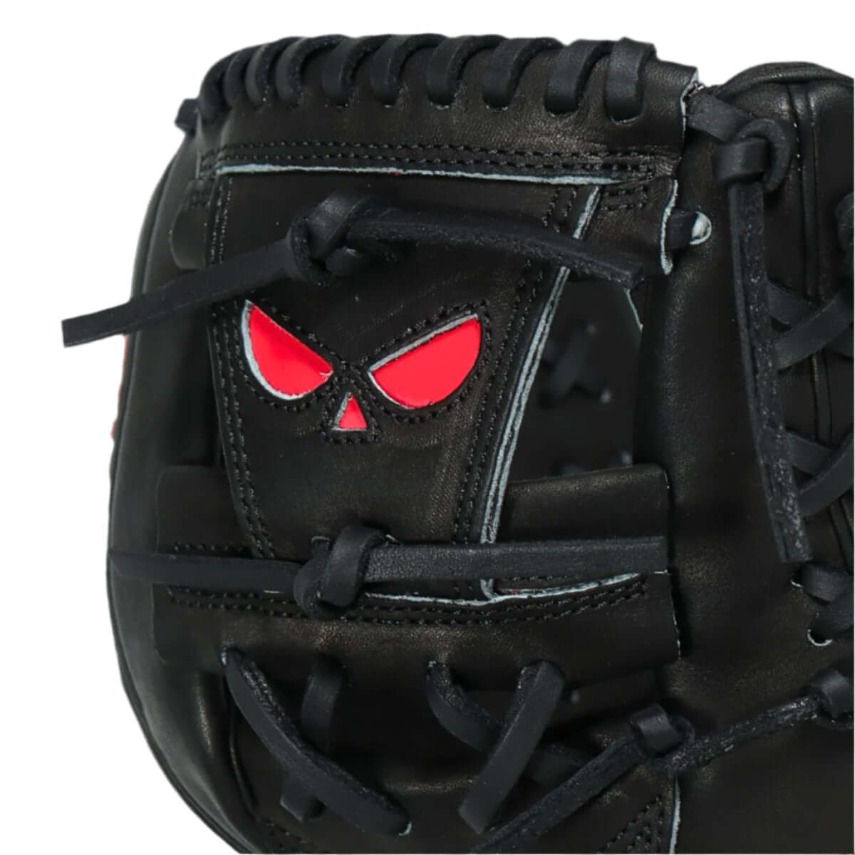 Close-up of the Shadow 19 Spade Baseball Glove, showcasing black leather with red skull design and intricate lacing.