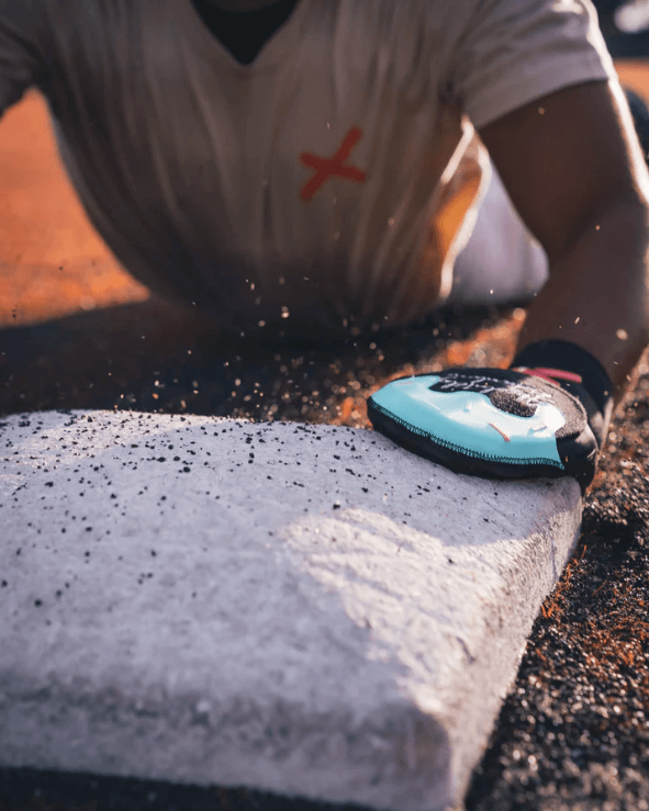 Close-up view of Pushin' P Youth Sliding Mitt - Absolutely Ridiculous Ice Cream Collection touching a baseball base.