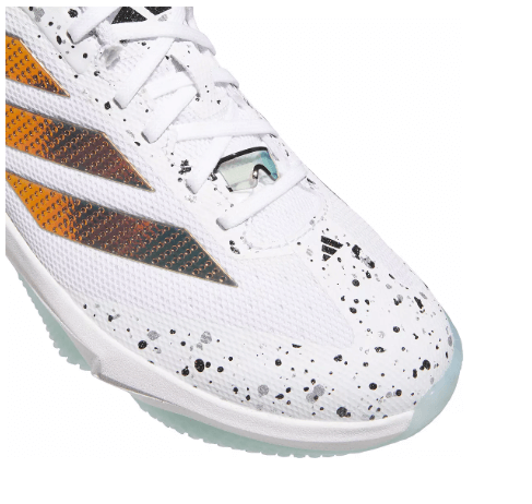 Close-up of Adidas Men's Adizero Impact 2.0 Shades Turf Baseball Shoes showing lacing and splatter design on the toe area.