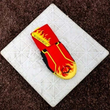 Evoshield X-SRZ Stay Hot Sliding Mitt 2.0 featuring a vibrant flame design on a cushioned surface. Perfect for baseball and softball.