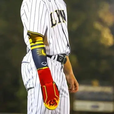 Evoshield X-SRZ Stay Hot Sliding Mitt 2.0 worn by a player in a striped baseball uniform during a game.