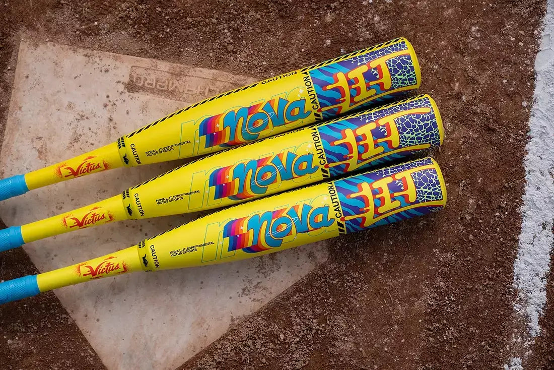 Top view of three Victus Nova LIT (-5) USSSA Baseball Bats on dirt field