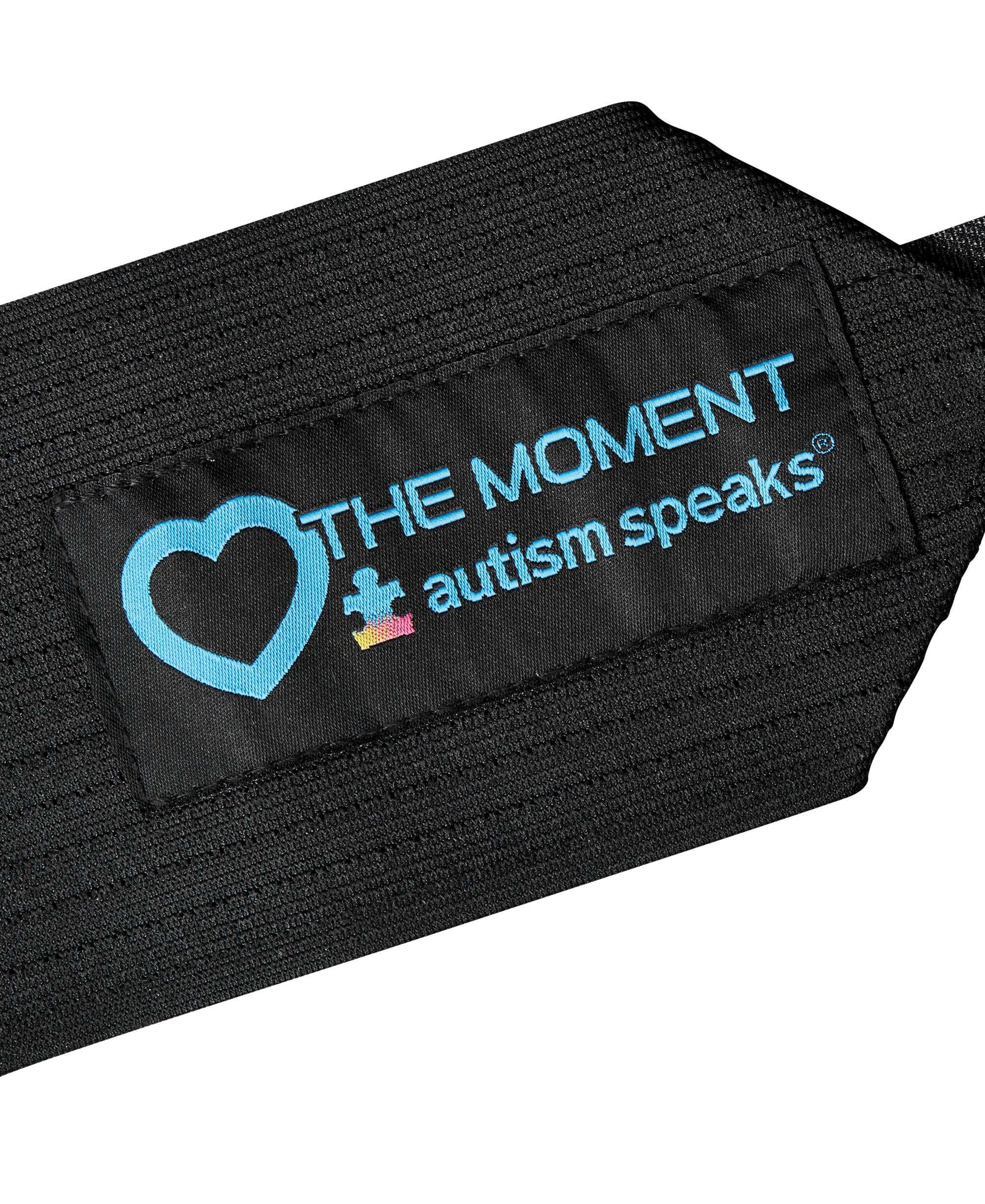 Close-up of Evoshield mitt featuring Autism Speaks "Love the Moment" logo, promoting awareness and support.