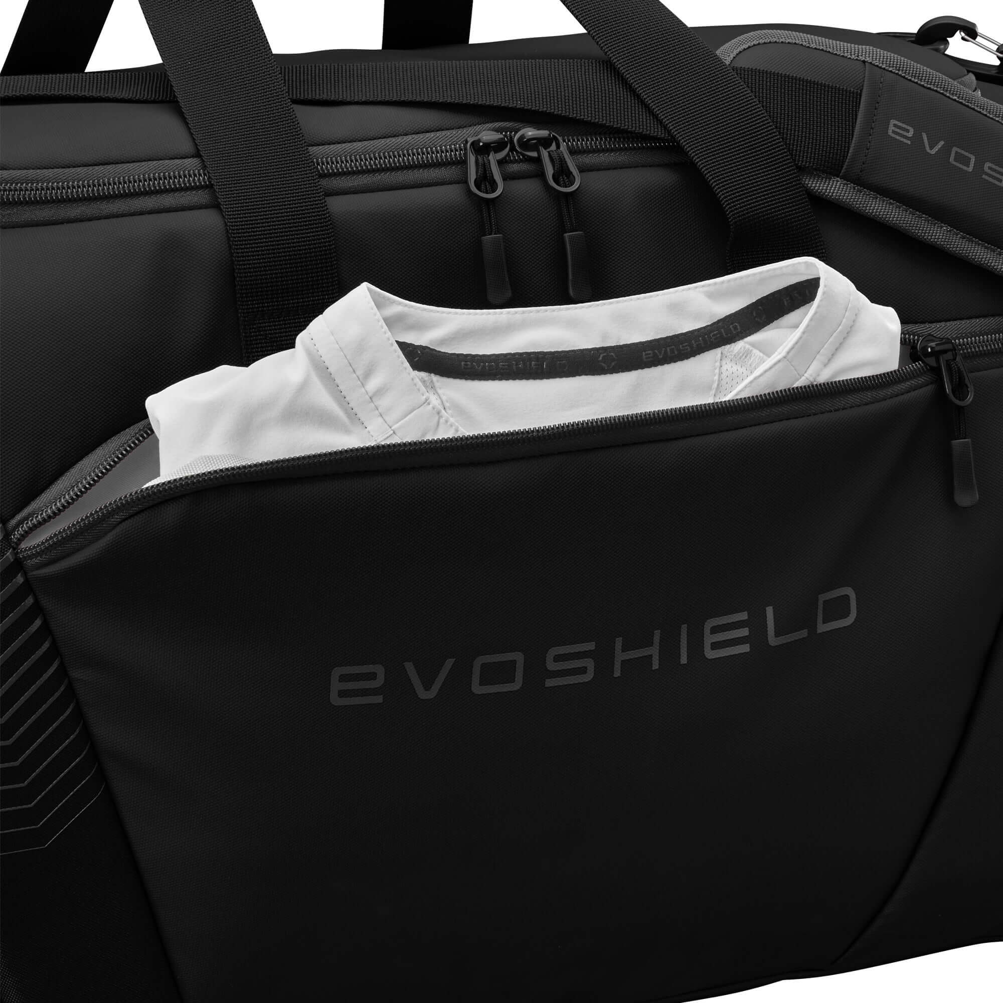 Evoshield Tone Set Players Duffle in black showing a front pocket with a folded shirt inside.