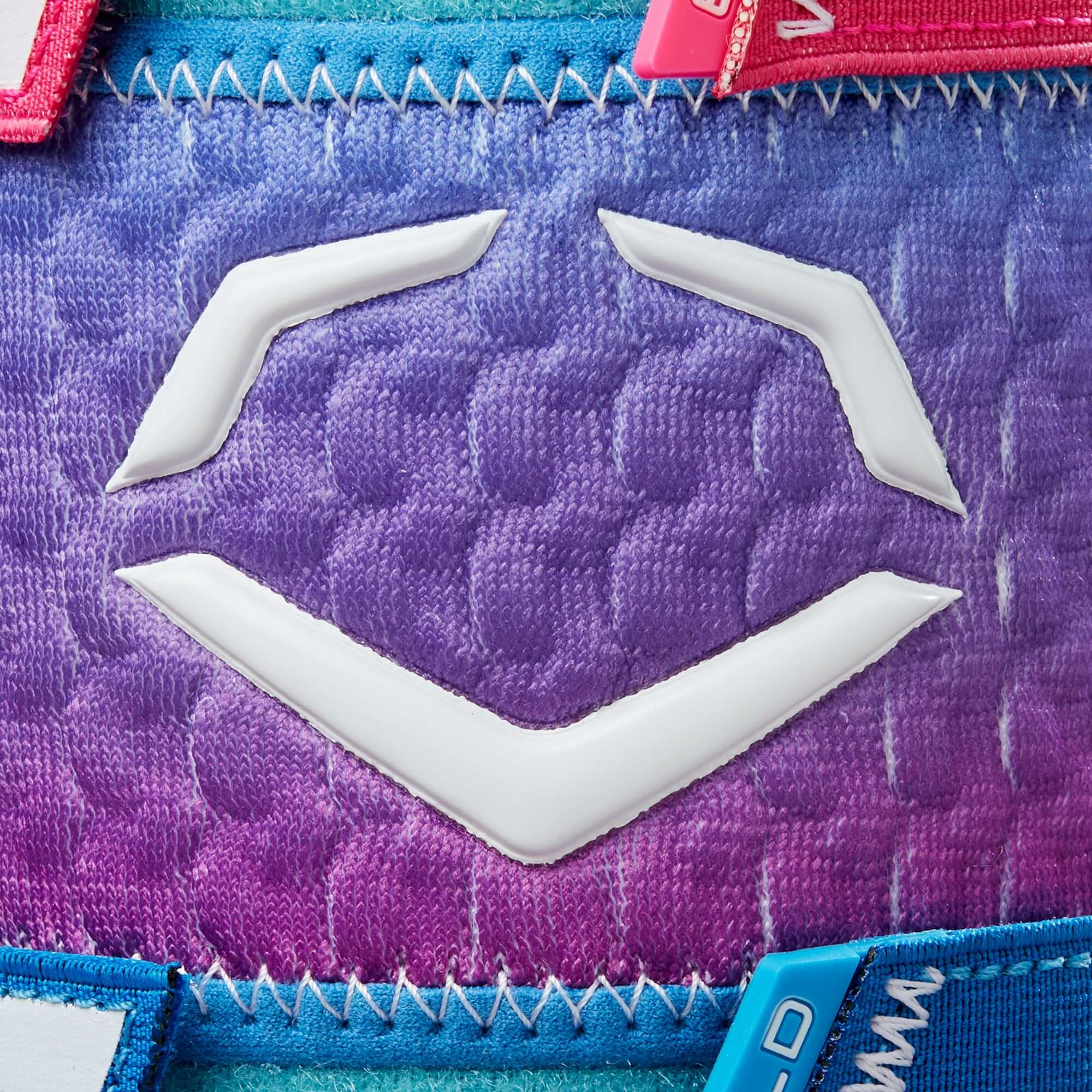 Evoshield logo design on the X-SRZ Autism Speaks leg guard featuring a pink and purple gradient pattern.