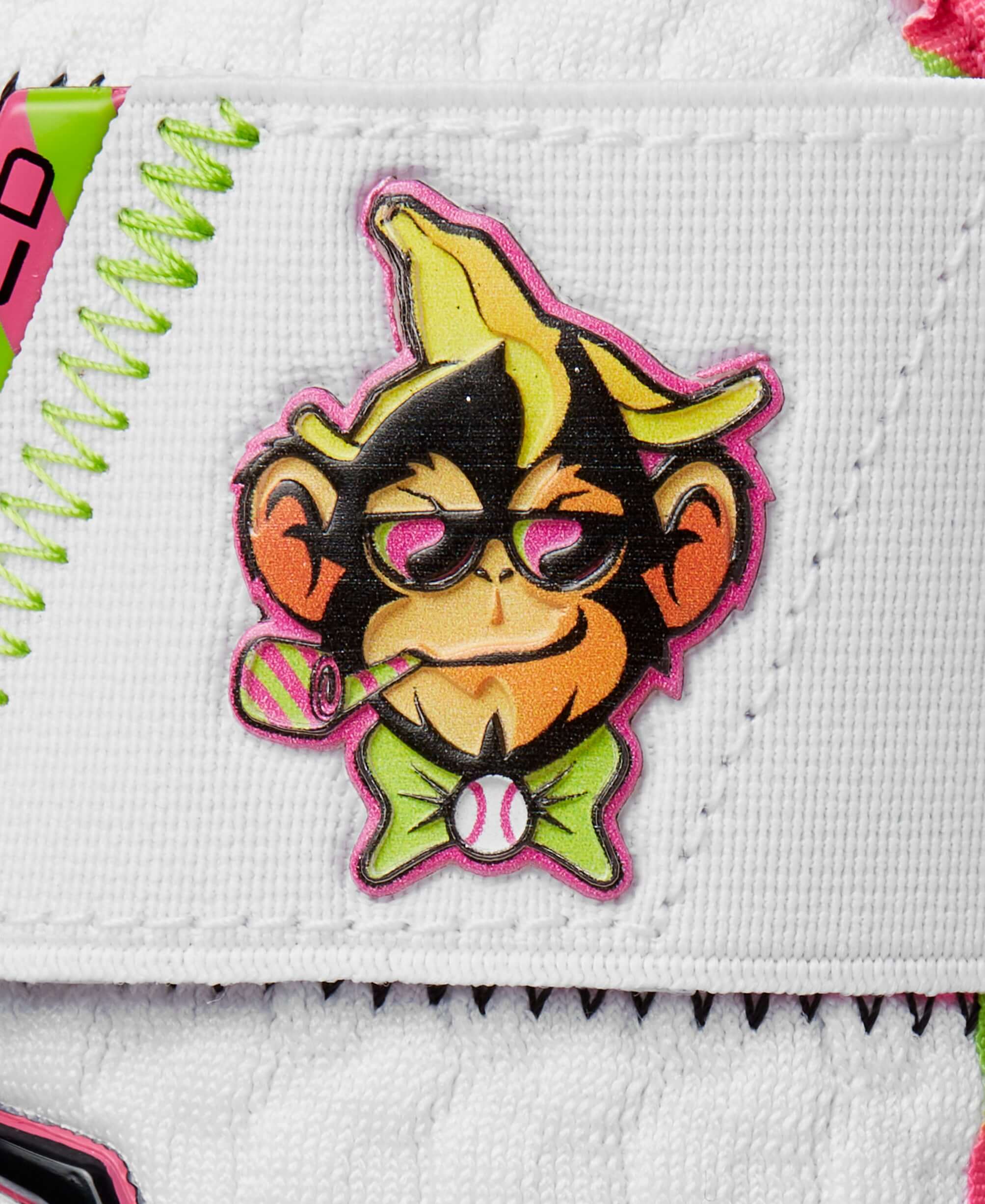 Cartoon monkey logo with a banana hat and sunglasses on the Evoshield leg guard.