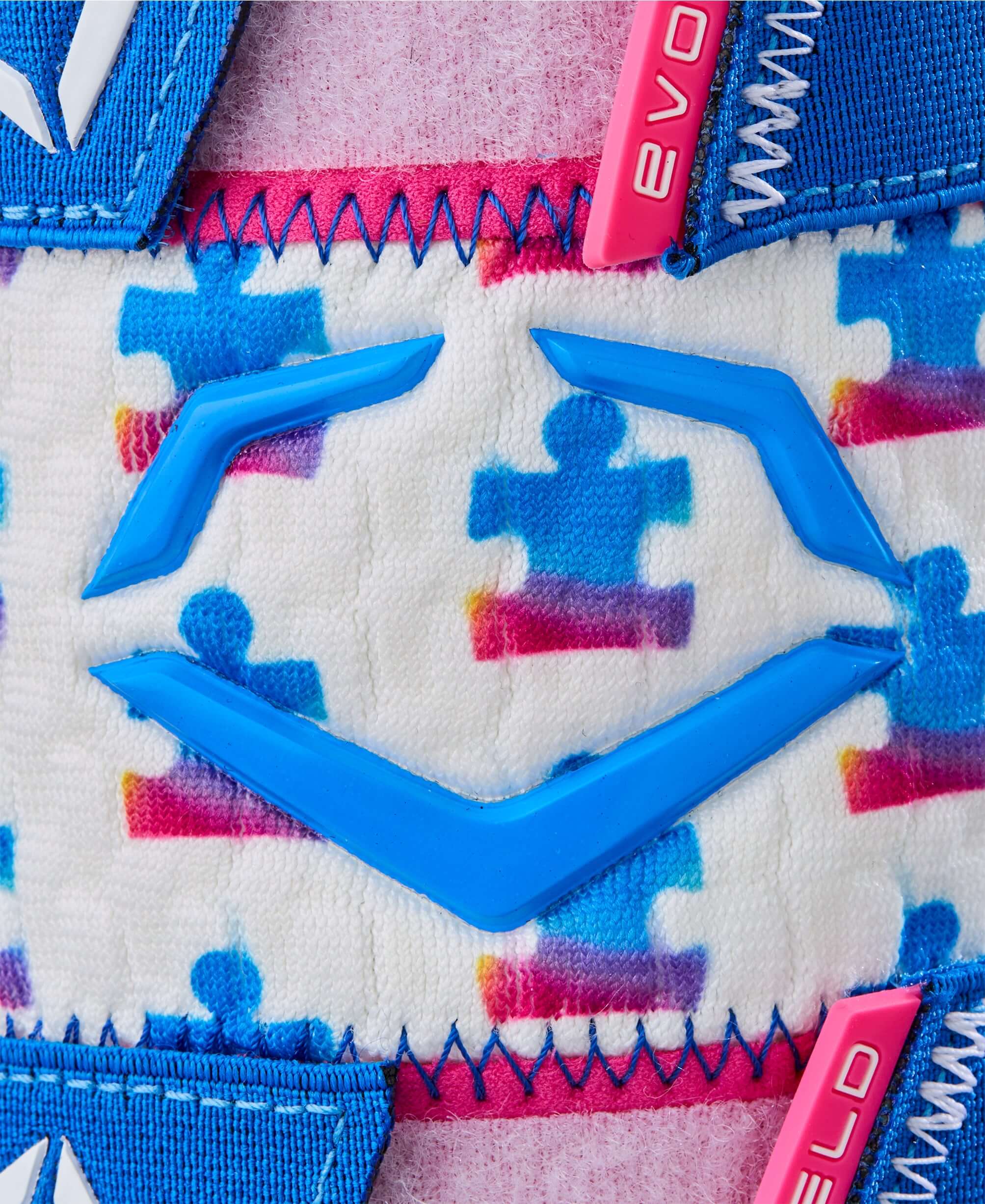 Close-up of Evoshield X-SRZ Love the Moment Batter's Leg Guard featuring colorful puzzle pattern and blue logo.