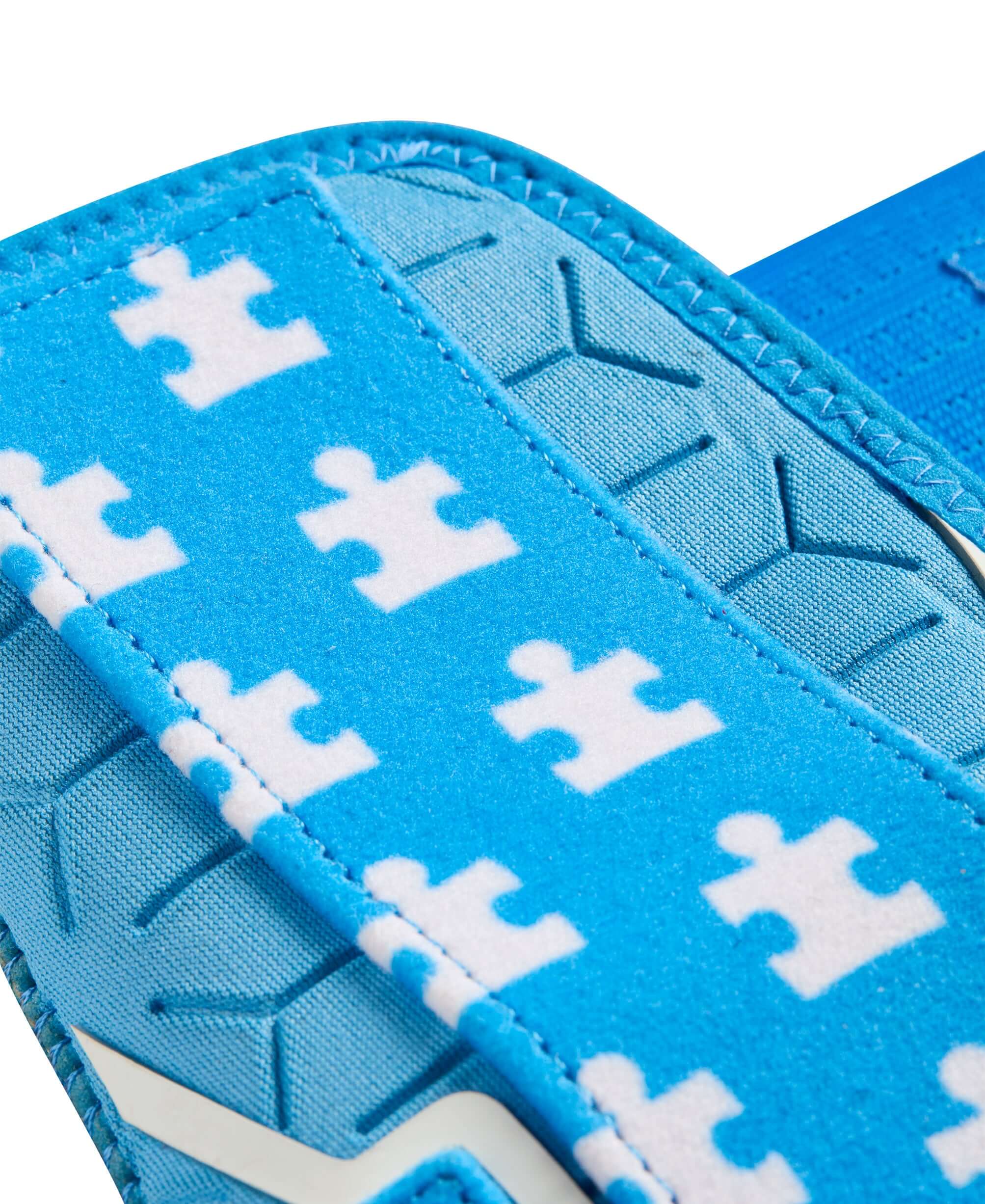 Close-up of Sky Blue elastic strap with puzzle piece pattern on EvoShield X-SRZ Love the Moment Sliding Mitt 2.0.