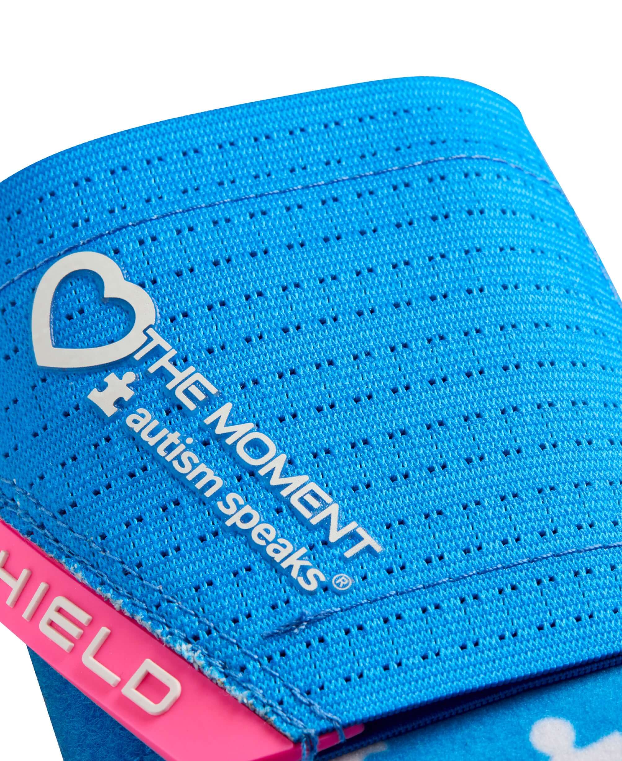 Close-up of EvoShield X-SRZ Love the Moment Sliding Mitt 2.0 featuring Autism Speaks logo on a vibrant blue background.