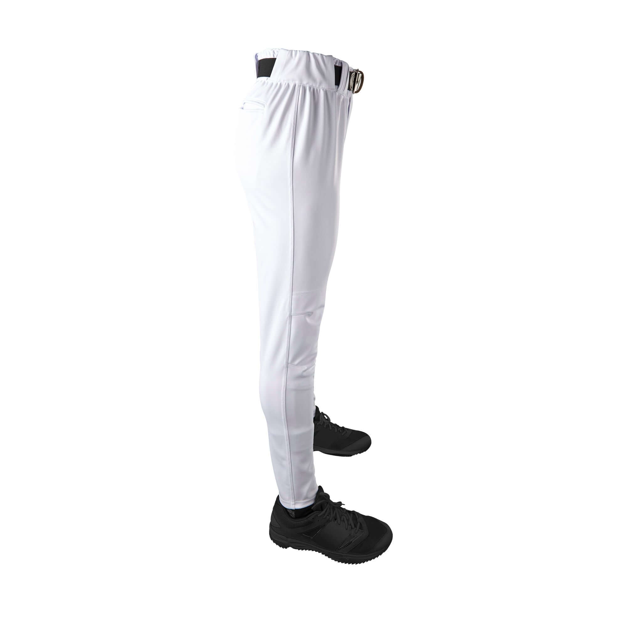 Profile view of Evoshield Men's CT Game Pant in white, showing slim fit and elastic waistband, worn with black athletic shoes.