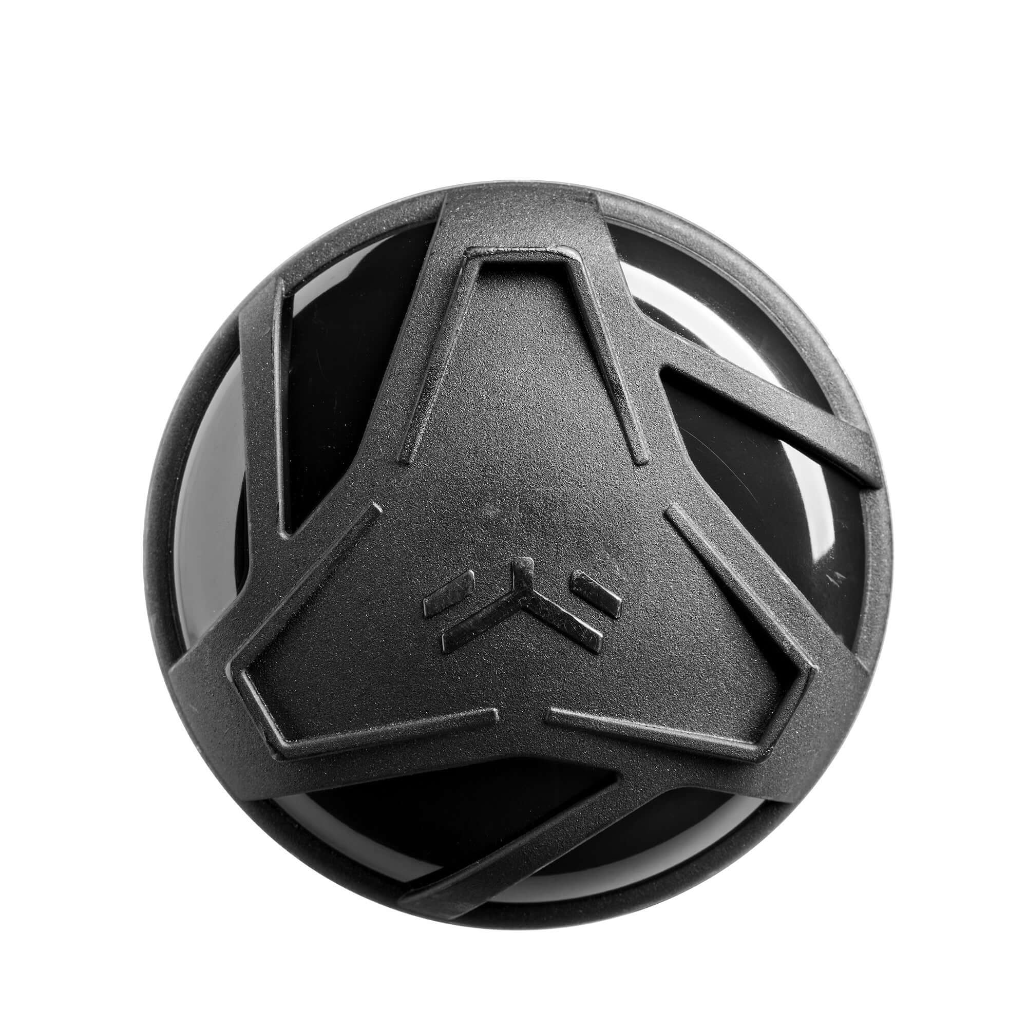 Close-up of a black circular device with a geometric design, showcasing its sleek modern appearance.