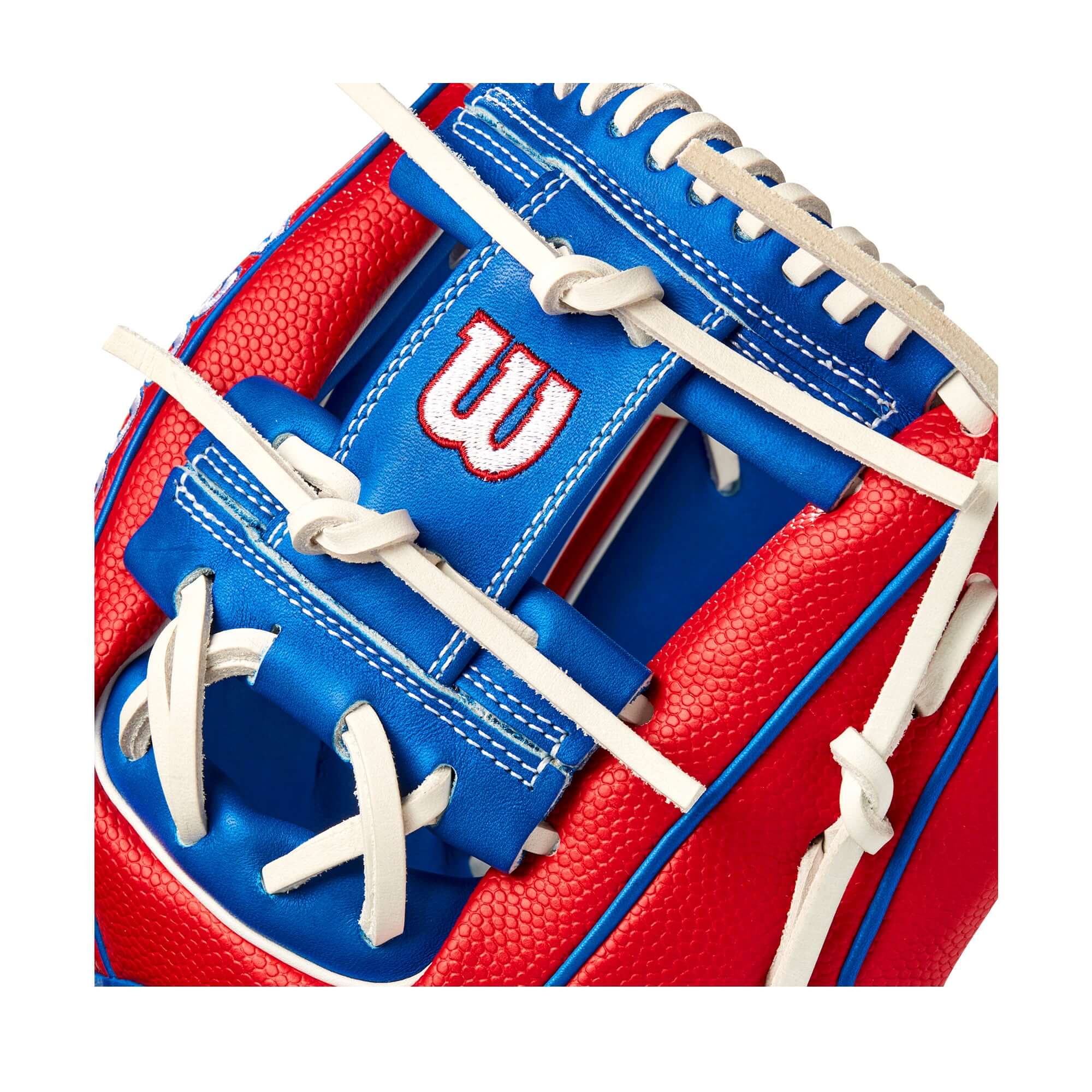 Close-up of Wilson A2000 1786 glove featuring red SuperSkin and royal blue Pro Stock leather with bold white logos.
