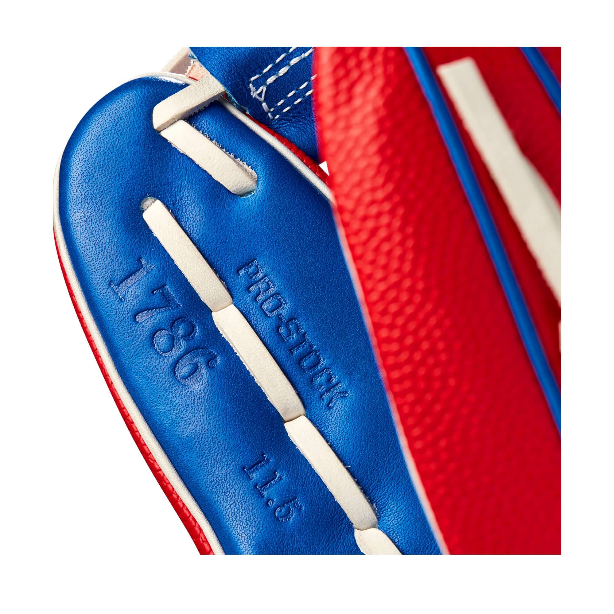 Close-up of Wilson A2000 1786 glove, featuring Red SuperSkin™ and Royal Blue Pro Stock® Leather, 11.5" size.